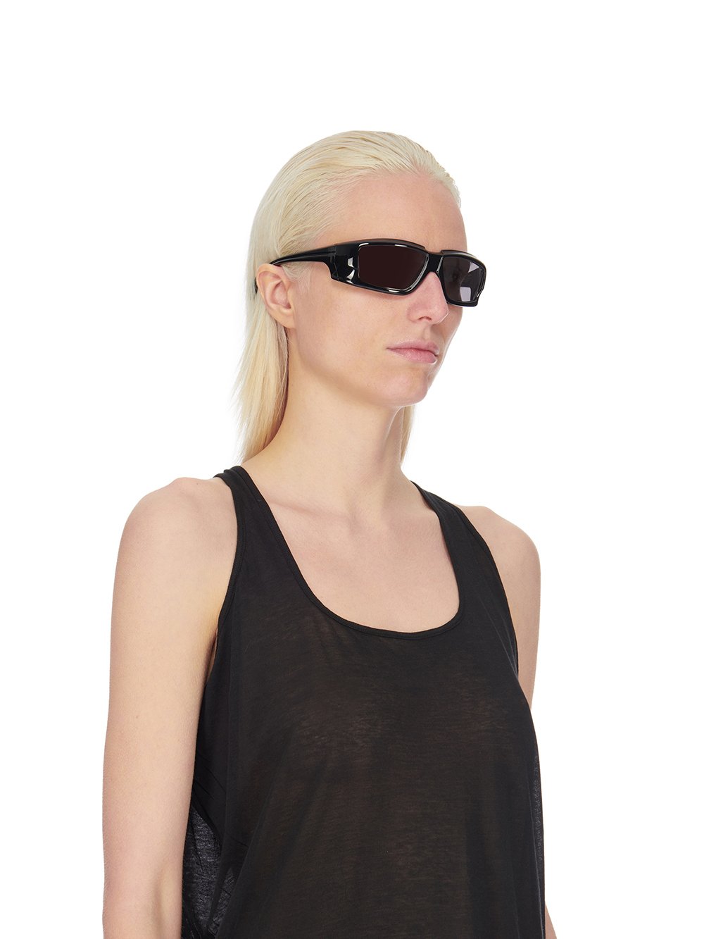 Rick Owens runway look featuring avant garde layered outfit with sculptural silhouette and dark tonal styling