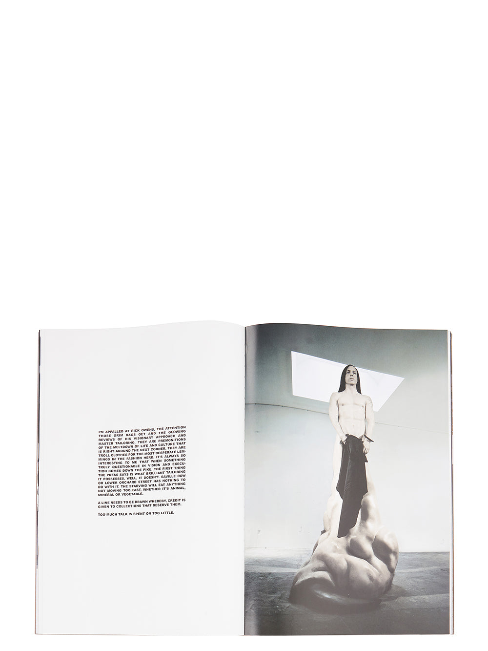 Rick Owens runway look featuring avant garde layered outfit with sculptural silhouette and dark tonal styling