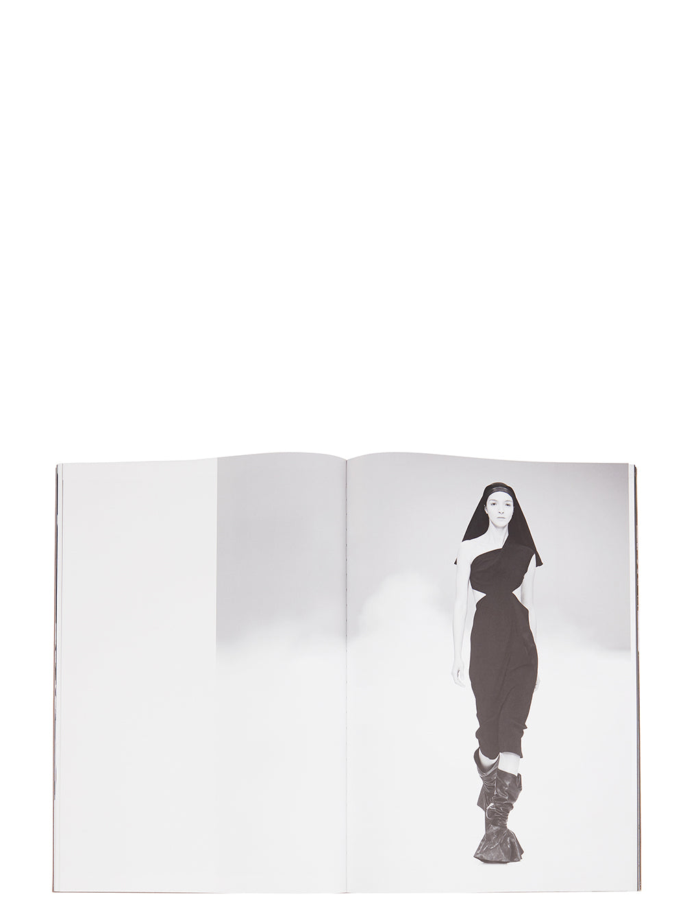 Rick Owens runway look featuring avant garde layered outfit with sculptural silhouette and dark tonal styling
