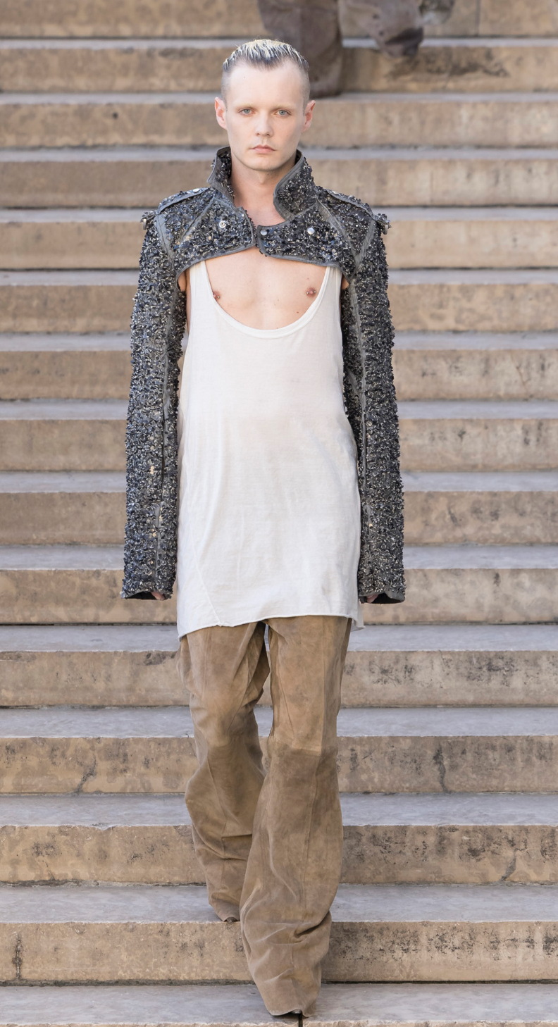 Rick Owens runway look featuring avant garde layered outfit with sculptural silhouette and dark tonal styling