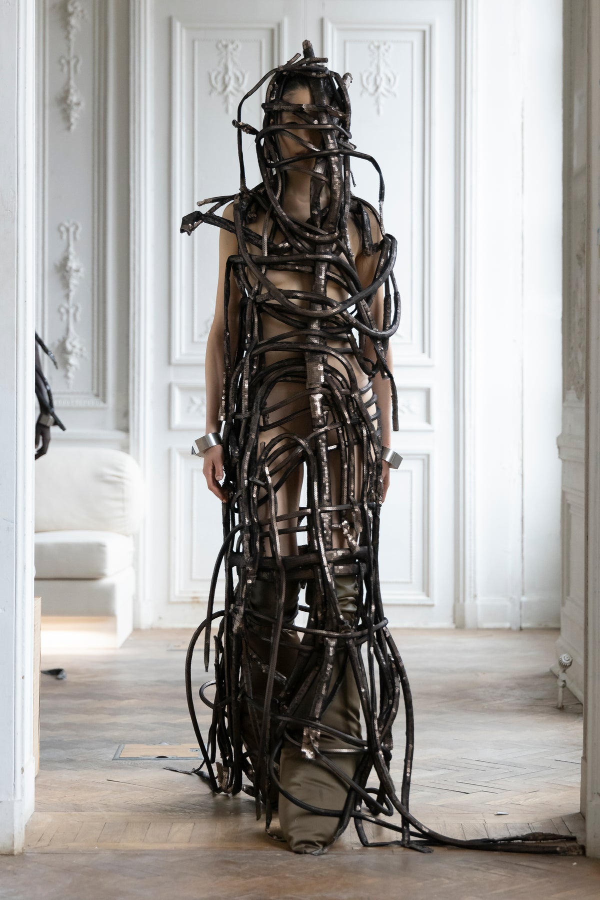 Rick Owens runway look featuring avant garde layered outfit with sculptural silhouette and dark tonal styling