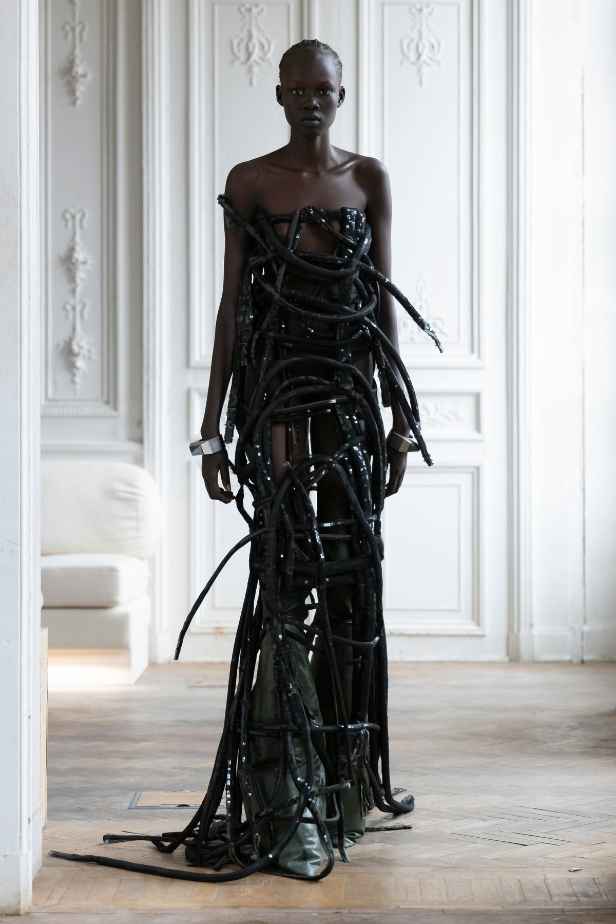 Rick Owens runway look featuring avant garde layered outfit with sculptural silhouette and dark tonal styling