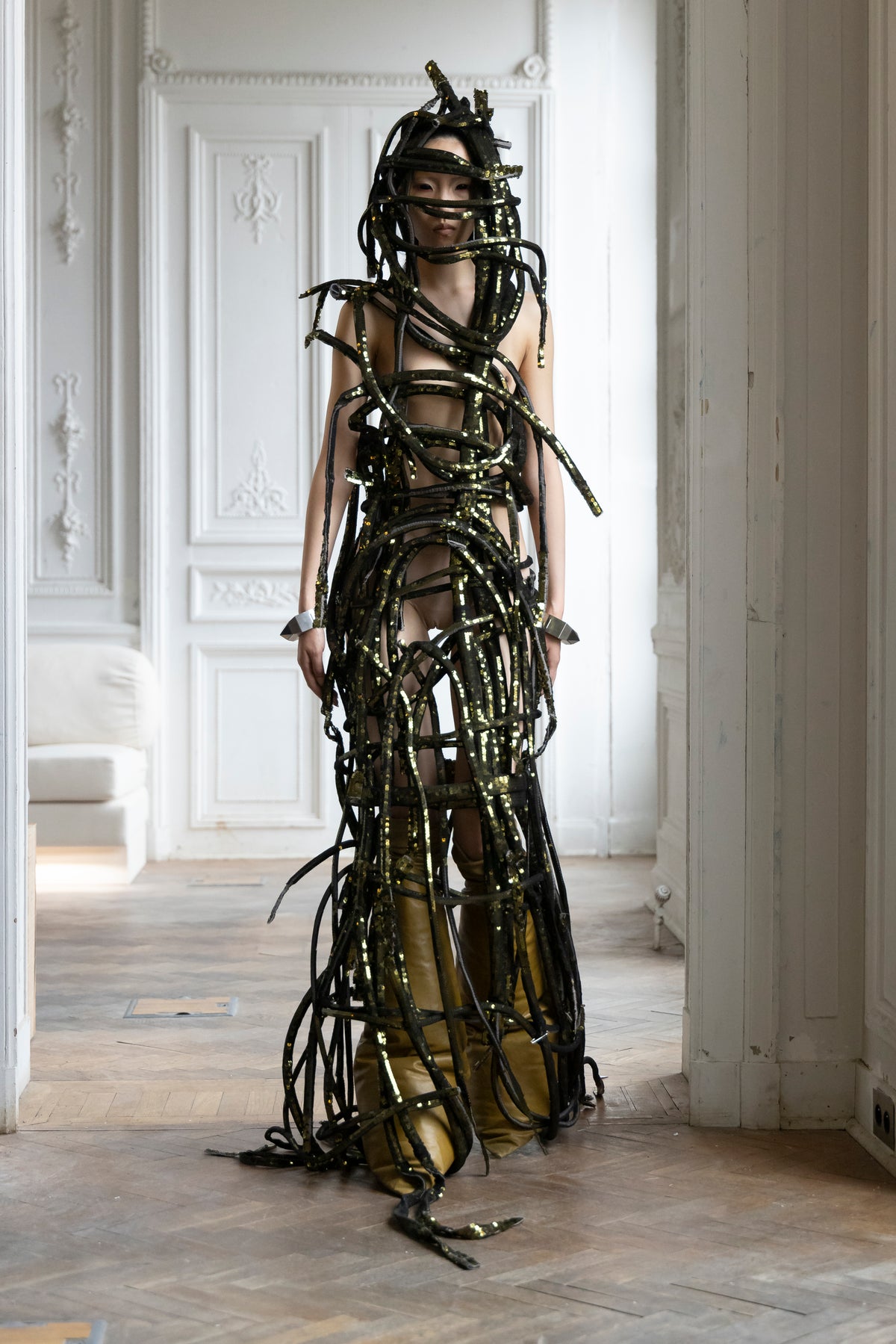 Rick Owens runway look featuring avant garde layered outfit with sculptural silhouette and dark tonal styling