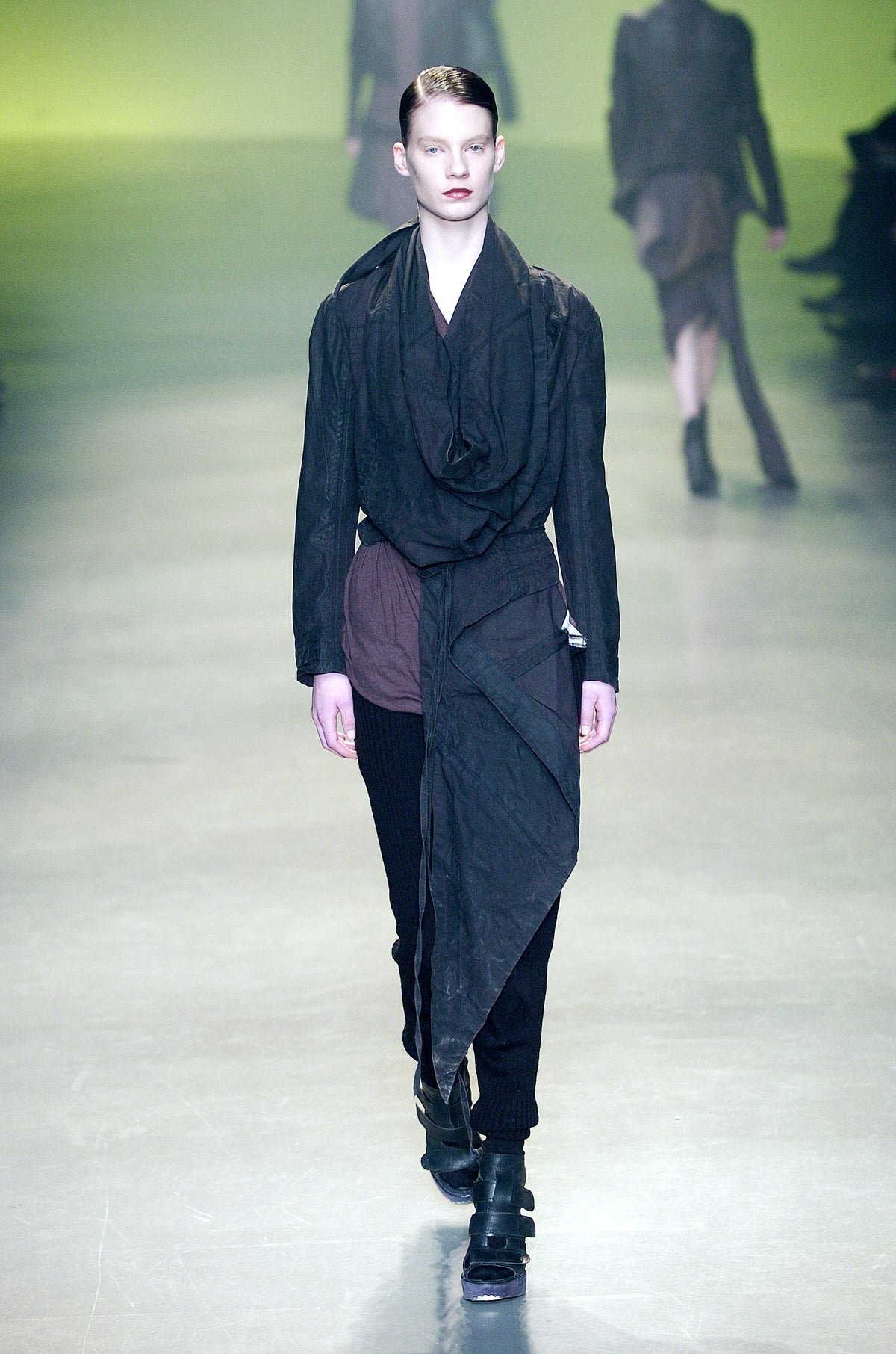 Rick Owens runway look featuring avant garde layered outfit with sculptural silhouette and dark tonal styling