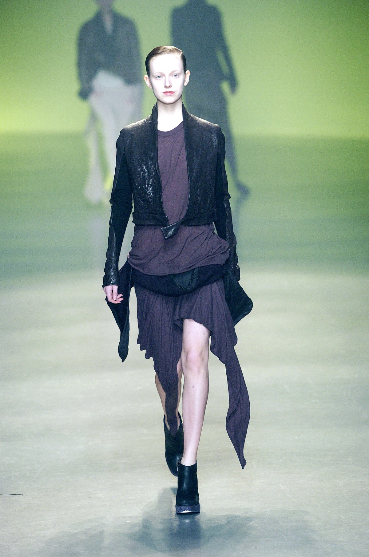 Rick Owens runway look featuring avant garde layered outfit with sculptural silhouette and dark tonal styling