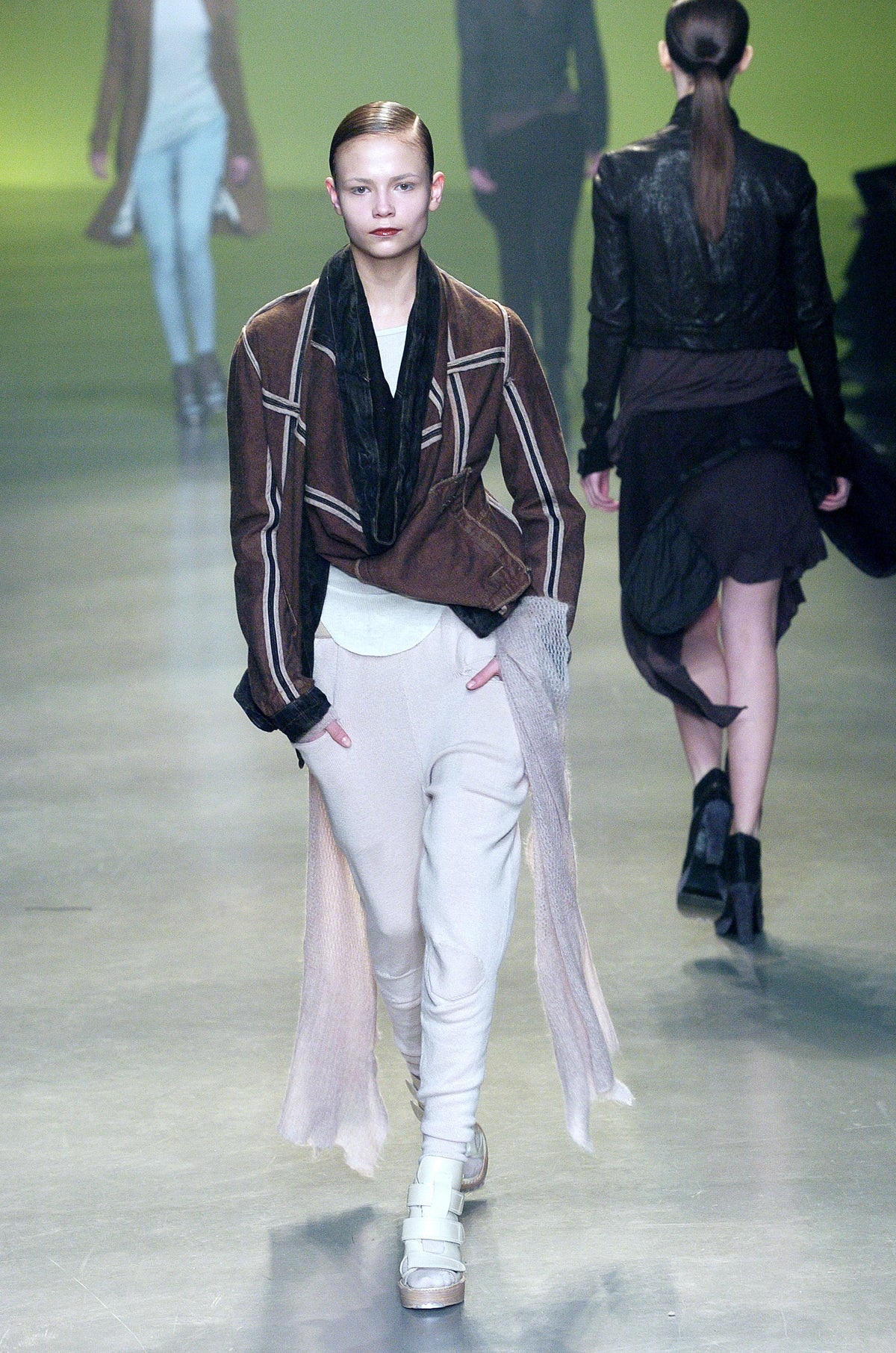 Rick Owens runway look featuring avant garde layered outfit with sculptural silhouette and dark tonal styling