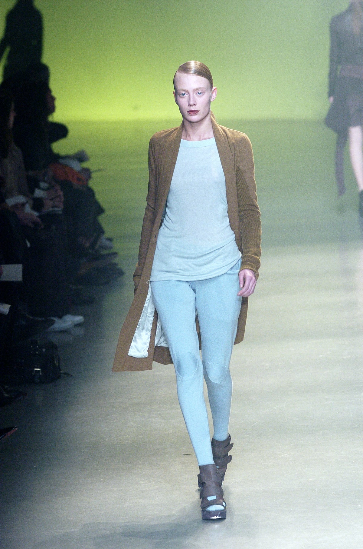 Rick Owens runway look featuring avant garde layered outfit with sculptural silhouette and dark tonal styling