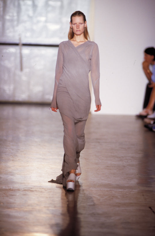 Rick Owens runway look featuring avant garde layered outfit with sculptural silhouette and dark tonal styling