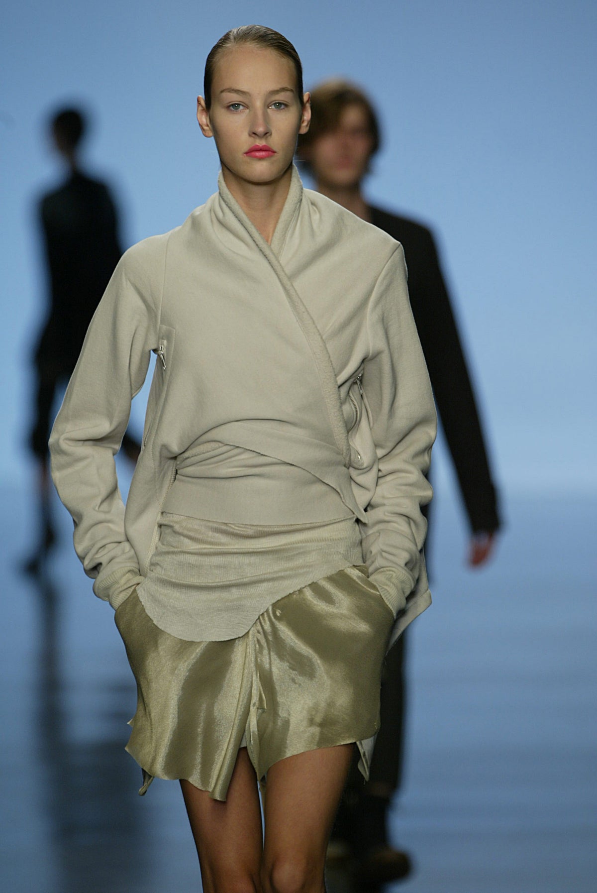 Rick Owens runway look featuring avant garde layered outfit with sculptural silhouette and dark tonal styling