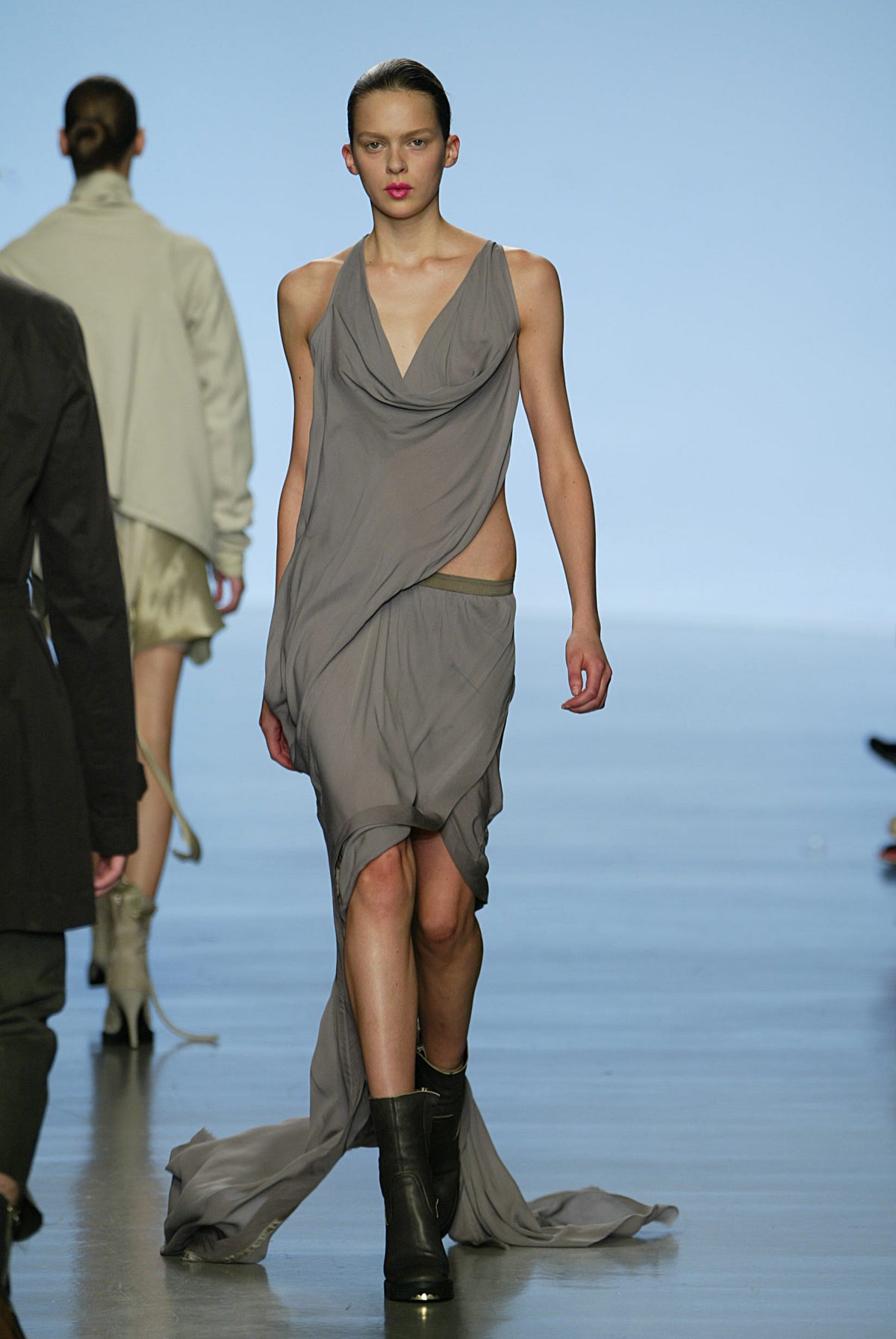 Rick Owens runway look featuring avant garde layered outfit with sculptural silhouette and dark tonal styling