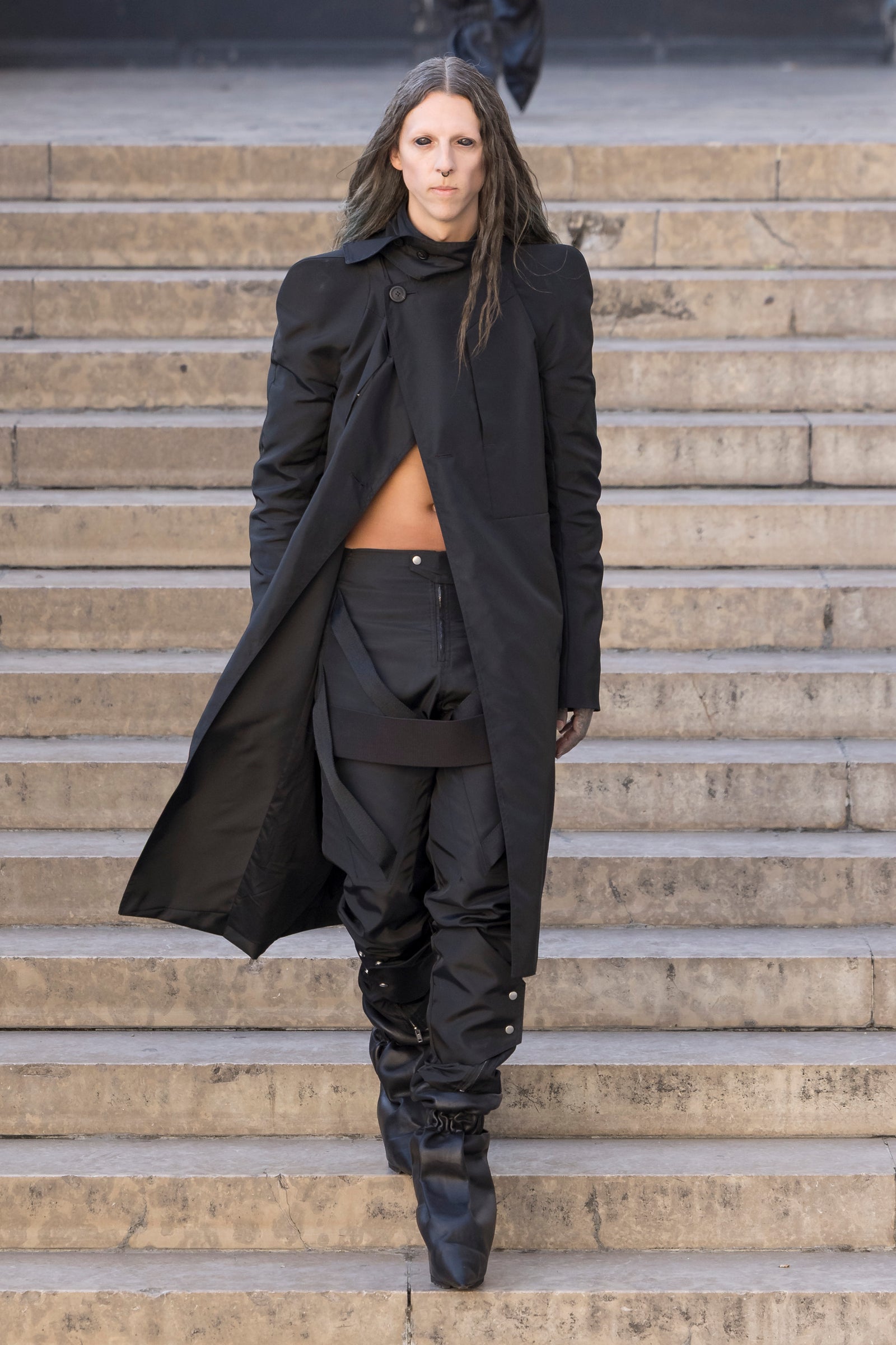 Rick Owens runway look featuring avant garde layered outfit with sculptural silhouette and dark tonal styling
