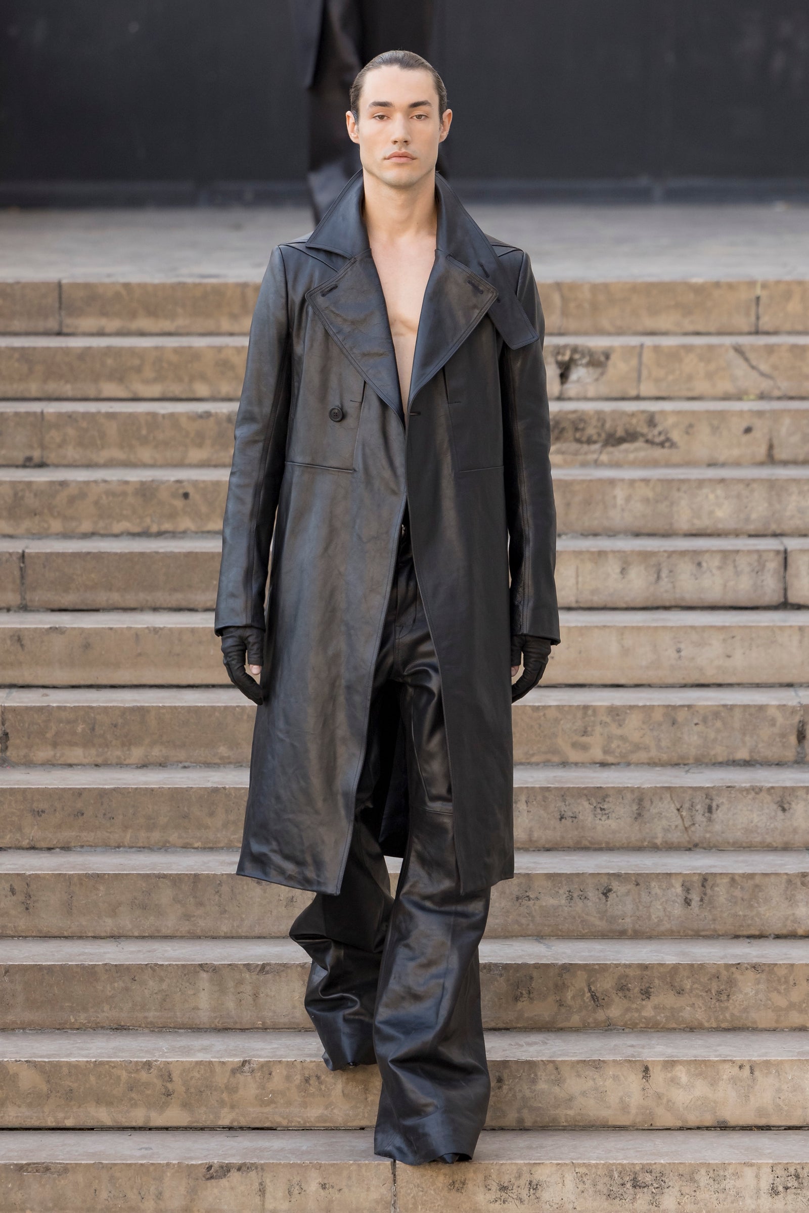 Rick Owens runway look featuring avant garde layered outfit with sculptural silhouette and dark tonal styling