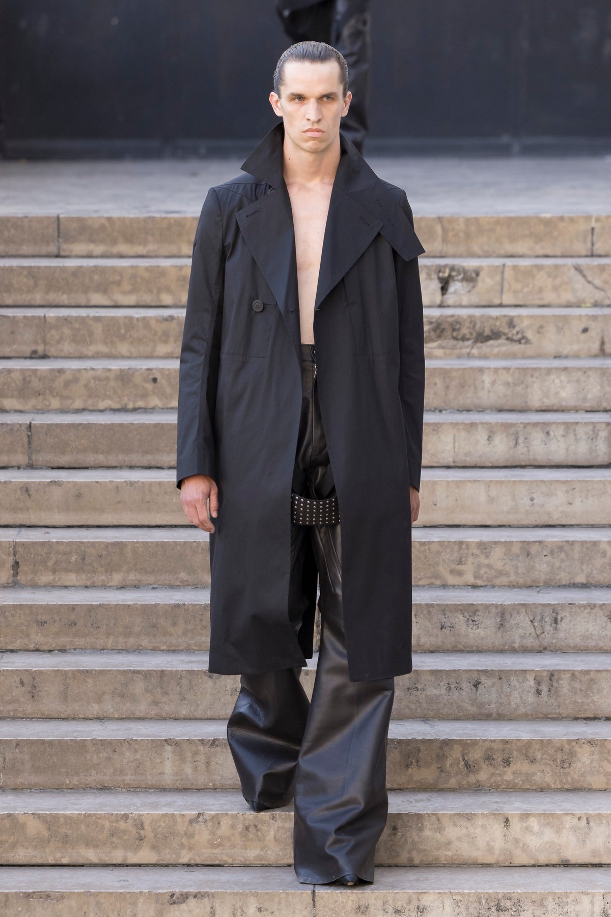 Rick Owens runway look featuring avant garde layered outfit with sculptural silhouette and dark tonal styling