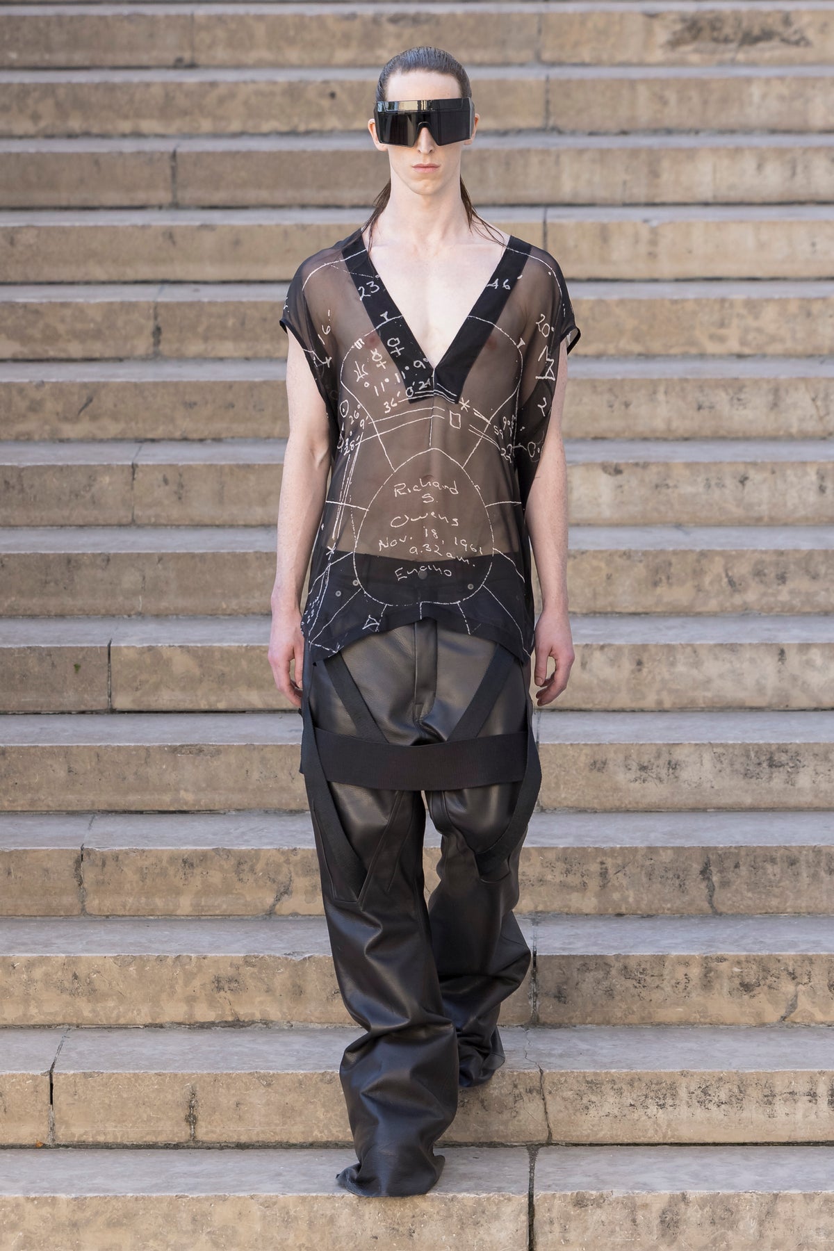 Rick Owens runway look featuring avant garde layered outfit with sculptural silhouette and dark tonal styling