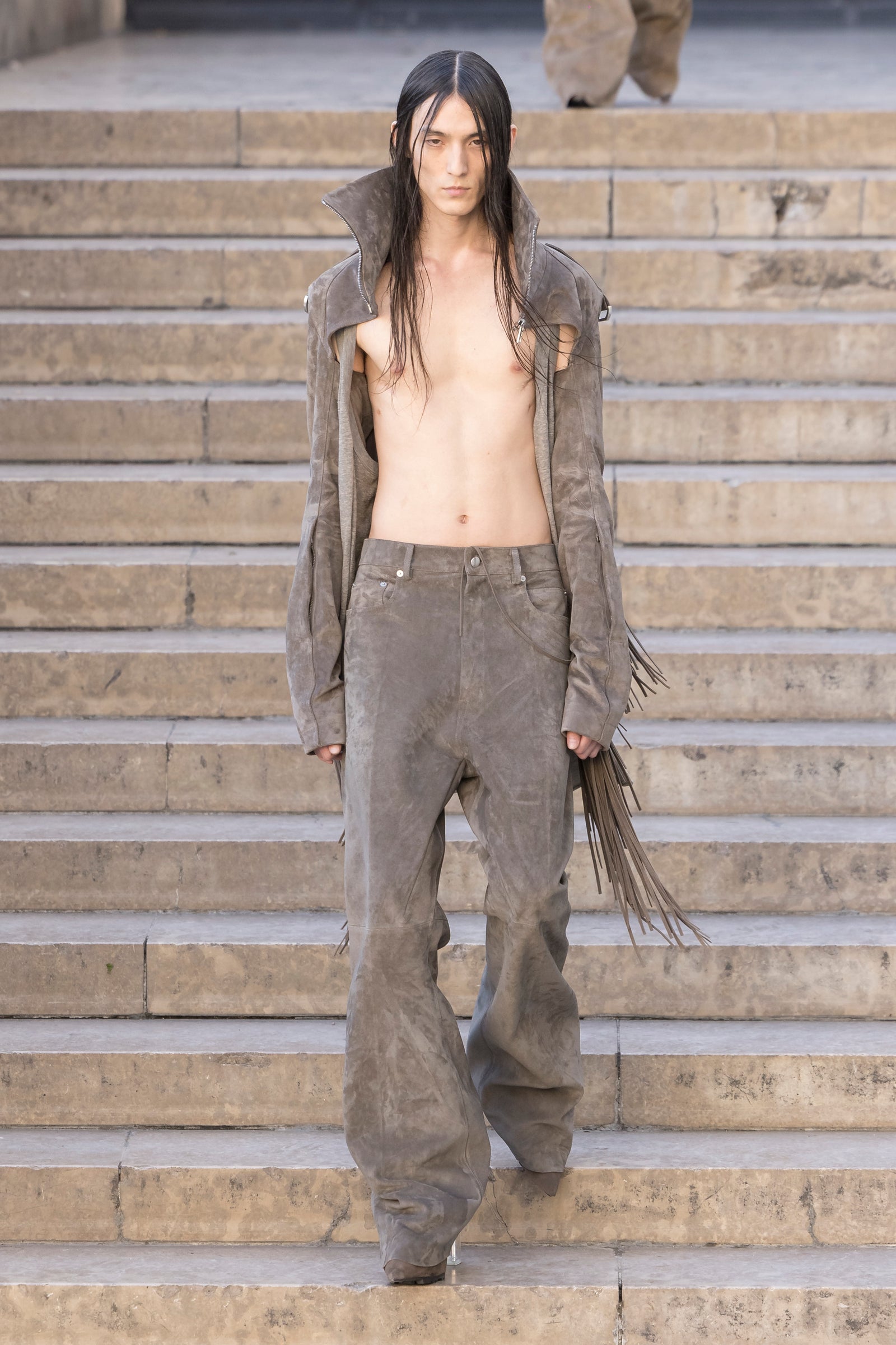 Rick Owens runway look featuring avant garde layered outfit with sculptural silhouette and dark tonal styling