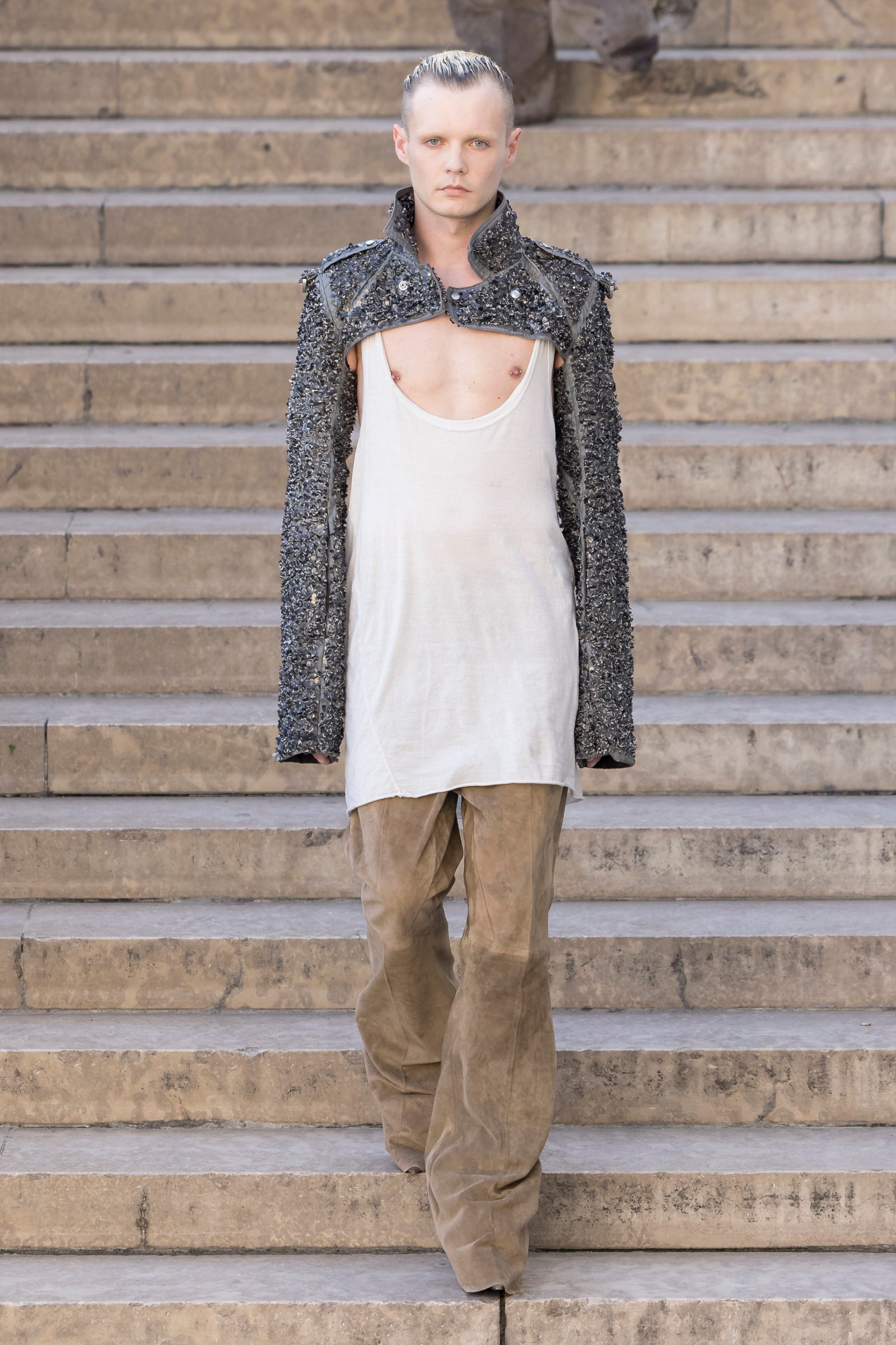 Rick Owens runway look featuring avant garde layered outfit with sculptural silhouette and dark tonal styling