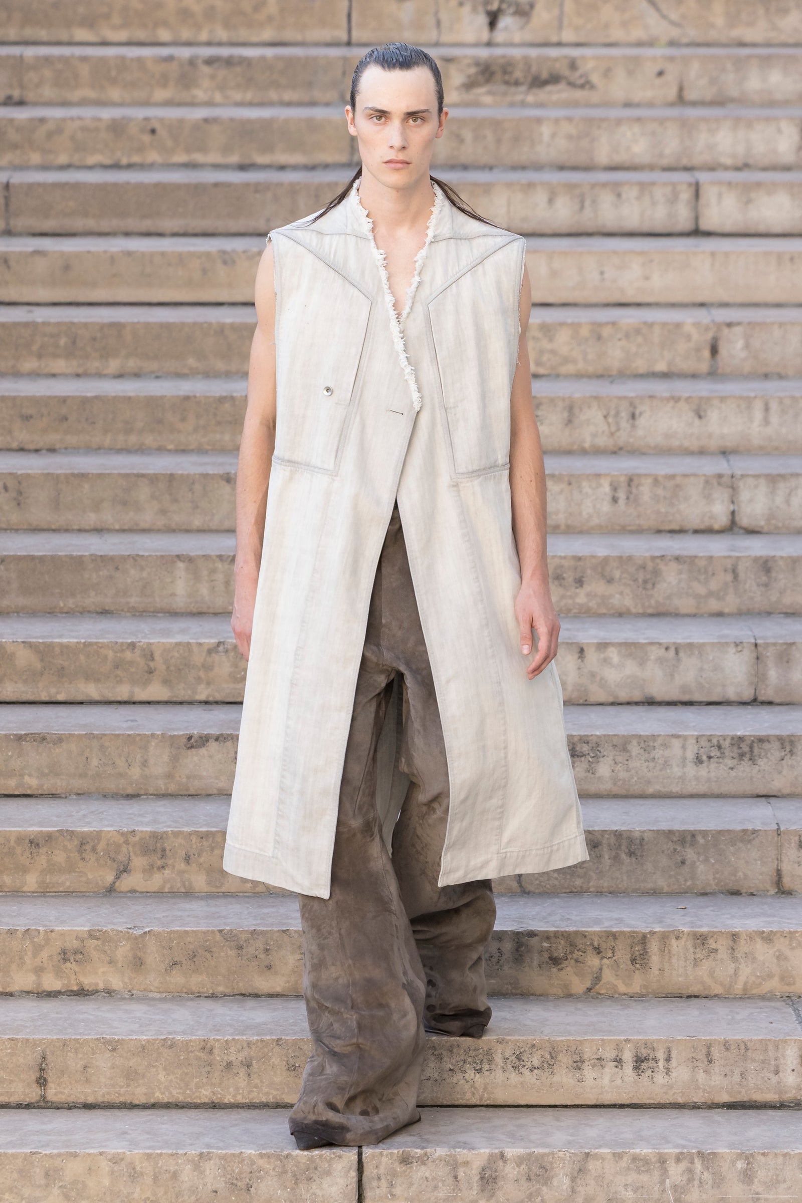 Rick Owens runway look featuring avant garde layered outfit with sculptural silhouette and dark tonal styling
