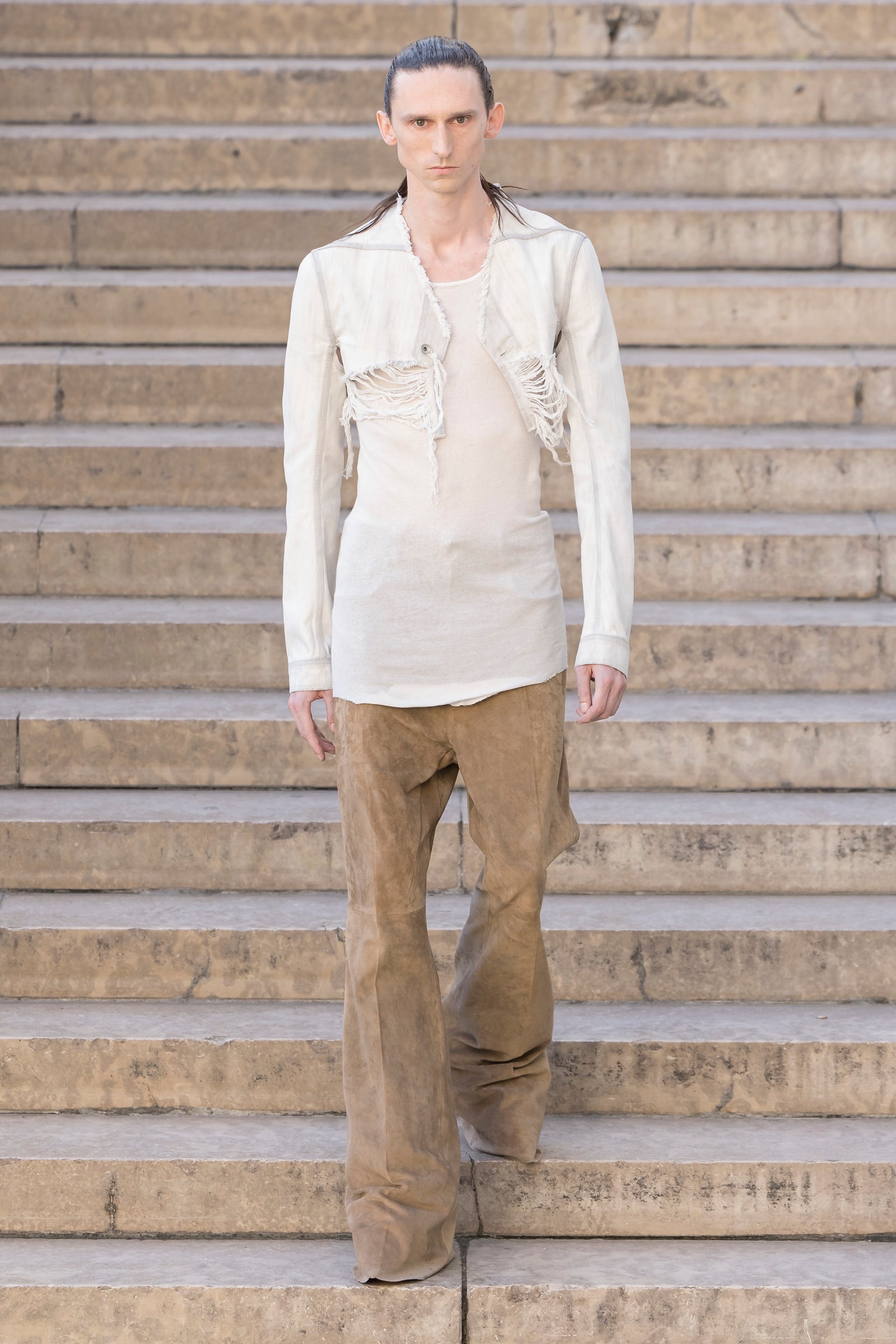 Rick Owens runway look featuring avant garde layered outfit with sculptural silhouette and dark tonal styling