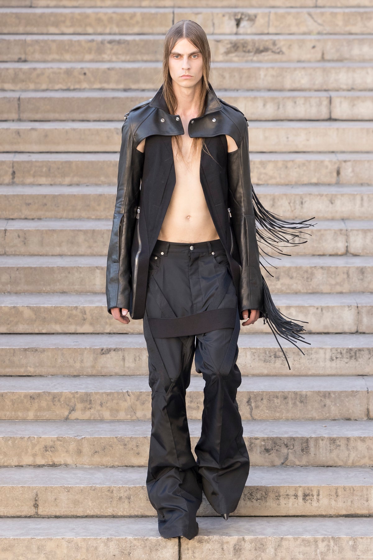 Rick Owens runway look featuring avant garde layered outfit with sculptural silhouette and dark tonal styling