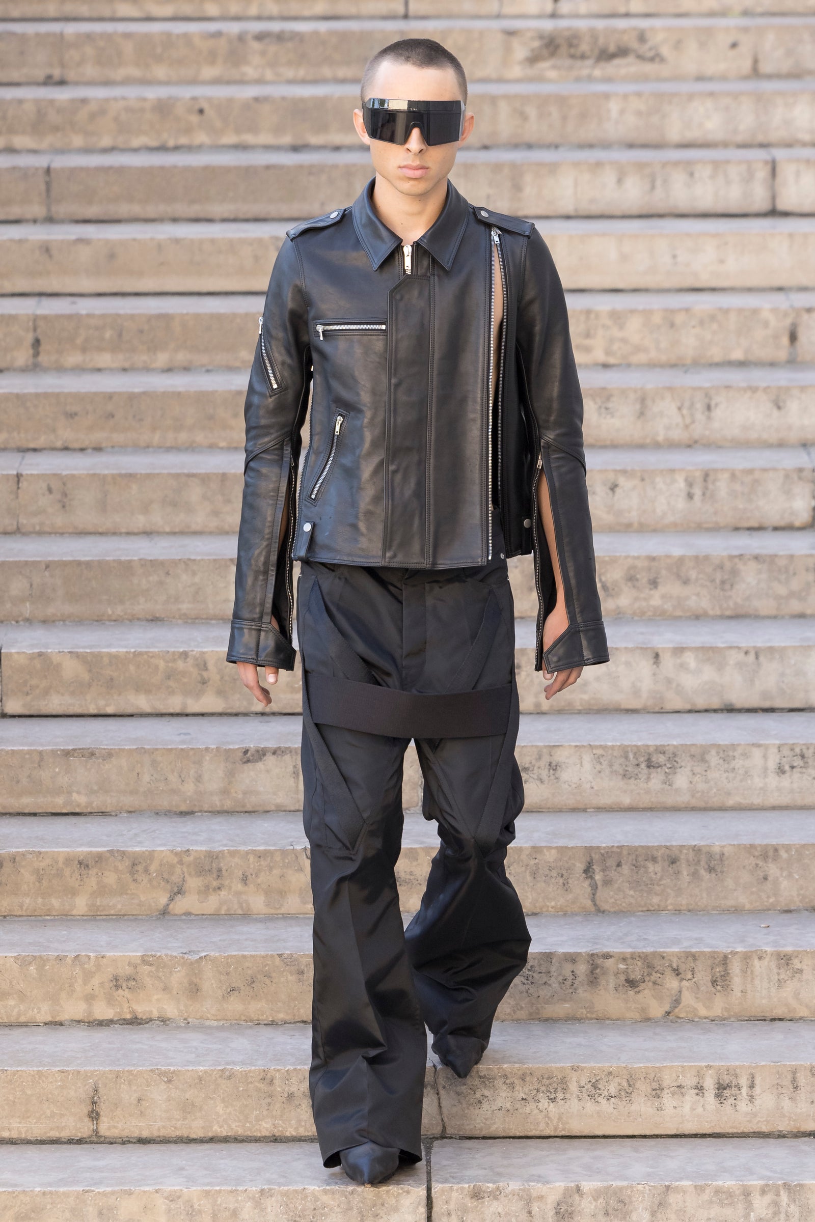 Rick Owens runway look featuring avant garde layered outfit with sculptural silhouette and dark tonal styling
