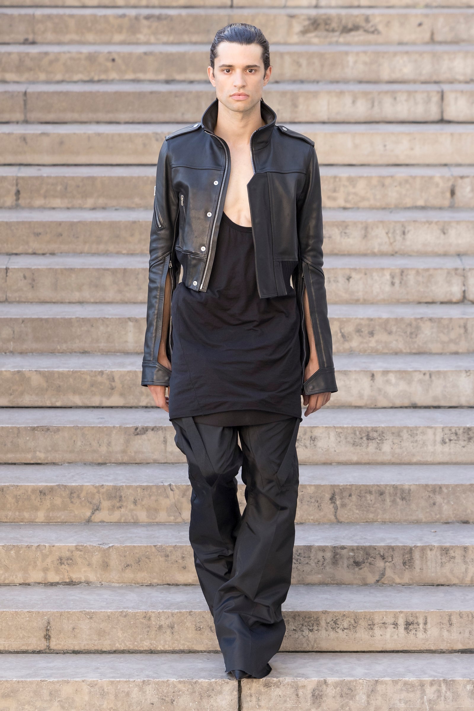 Rick Owens runway look featuring avant garde layered outfit with sculptural silhouette and dark tonal styling