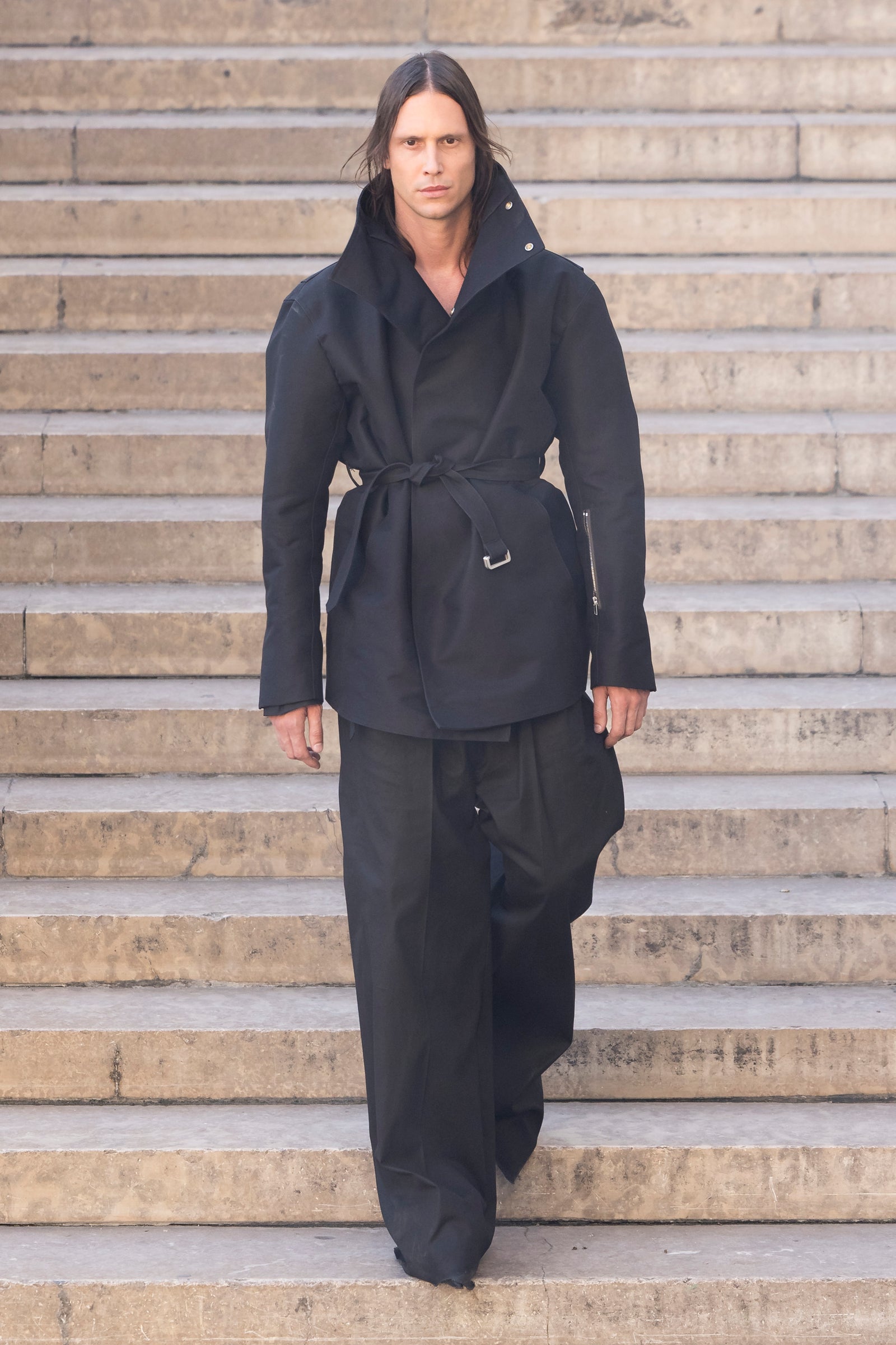 Rick Owens runway look featuring avant garde layered outfit with sculptural silhouette and dark tonal styling
