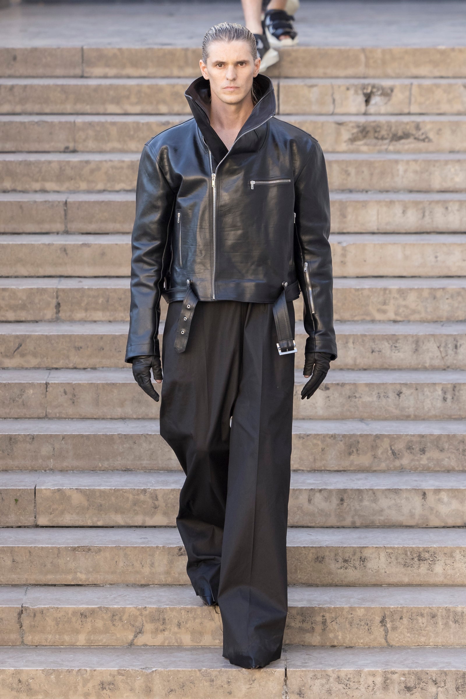 Rick Owens runway look featuring avant garde layered outfit with sculptural silhouette and dark tonal styling