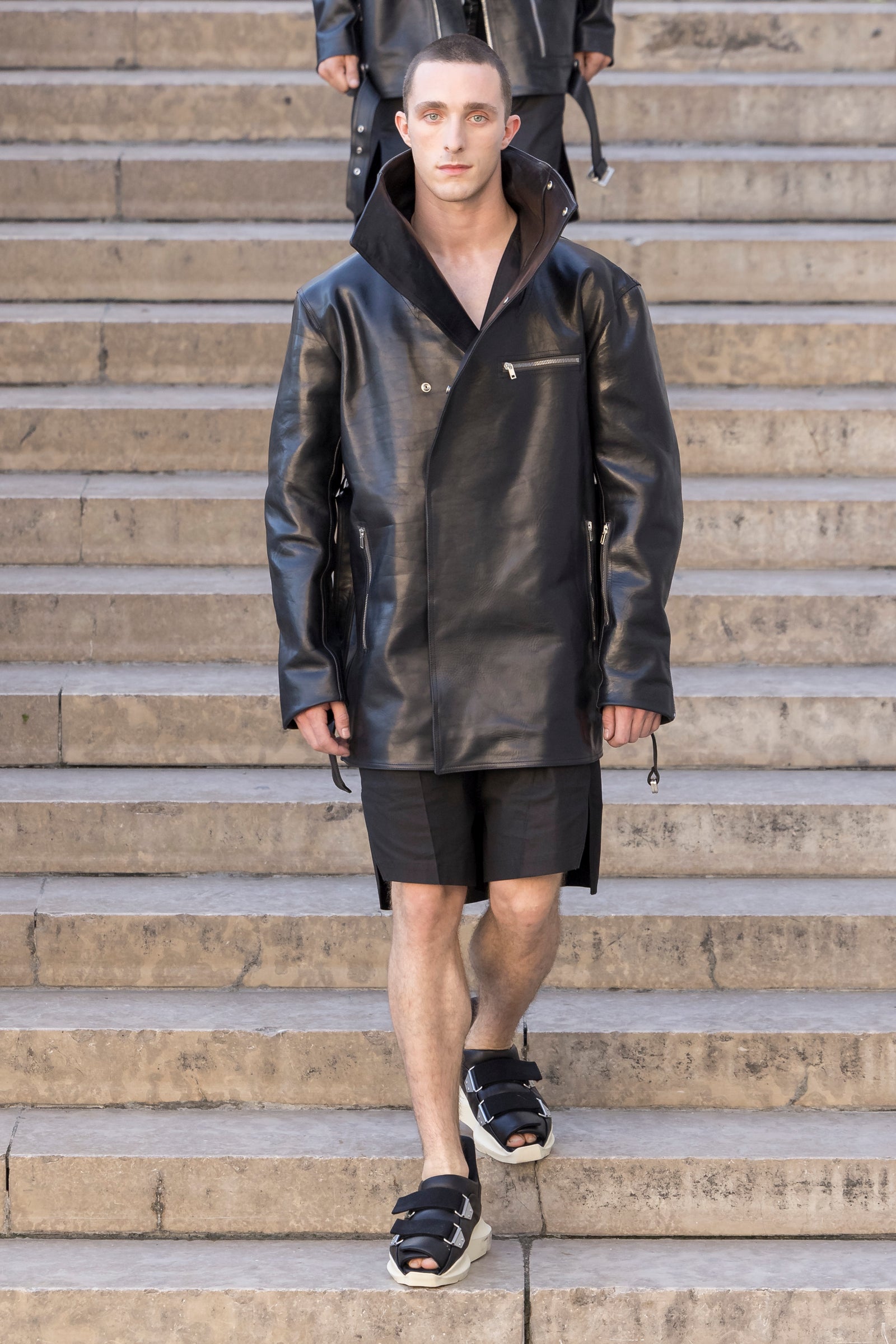 Rick Owens runway look featuring avant garde layered outfit with sculptural silhouette and dark tonal styling
