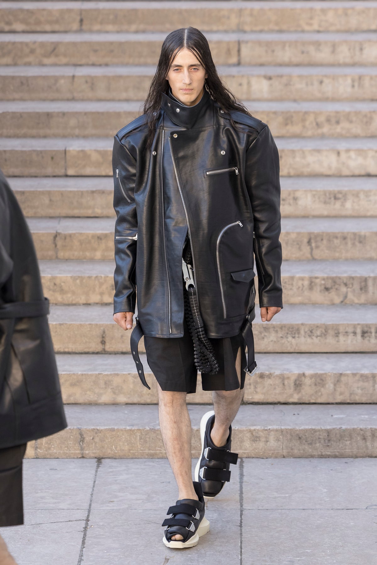 Rick Owens runway look featuring avant garde layered outfit with sculptural silhouette and dark tonal styling