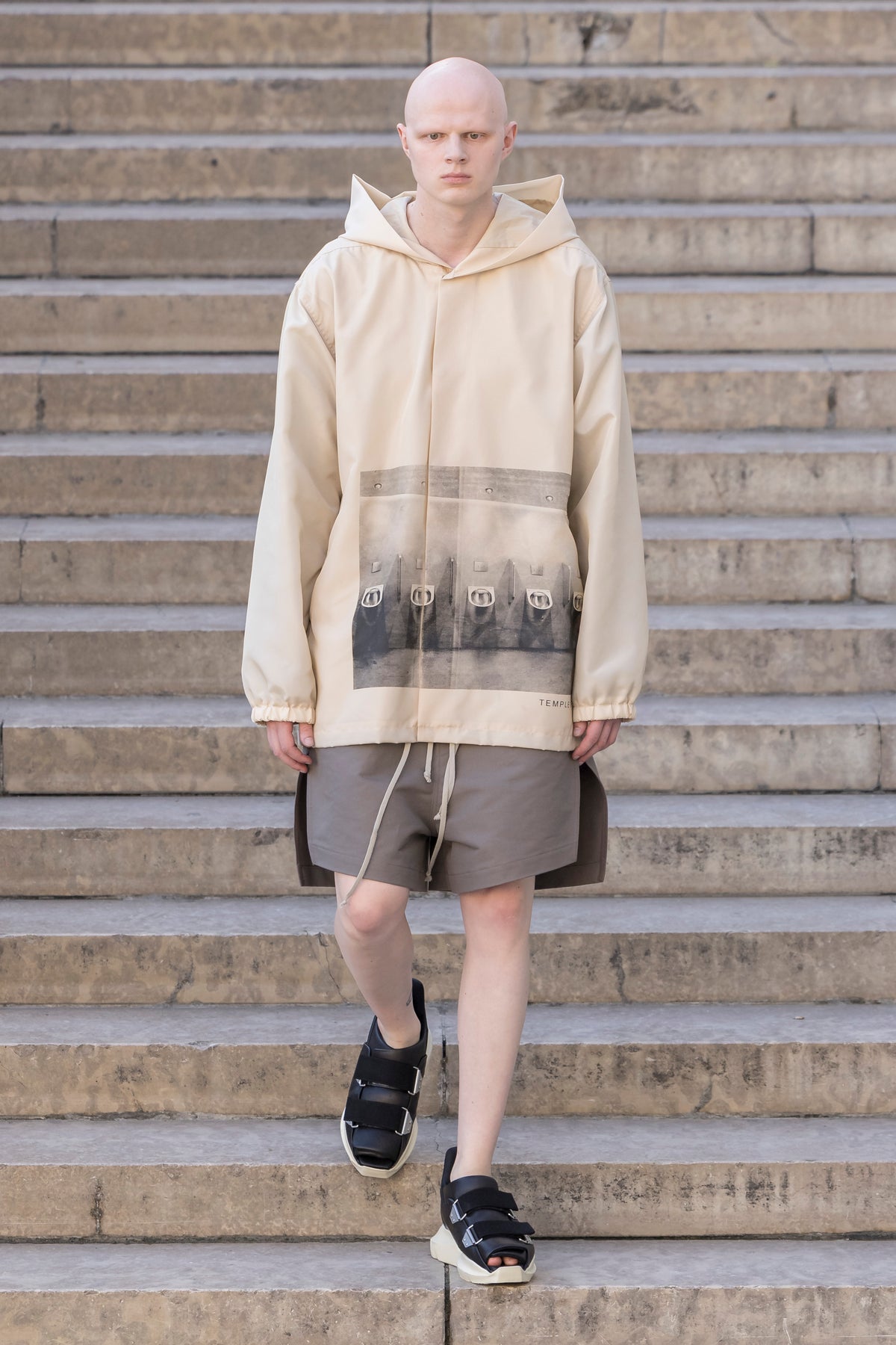 Rick Owens runway look featuring avant garde layered outfit with sculptural silhouette and dark tonal styling