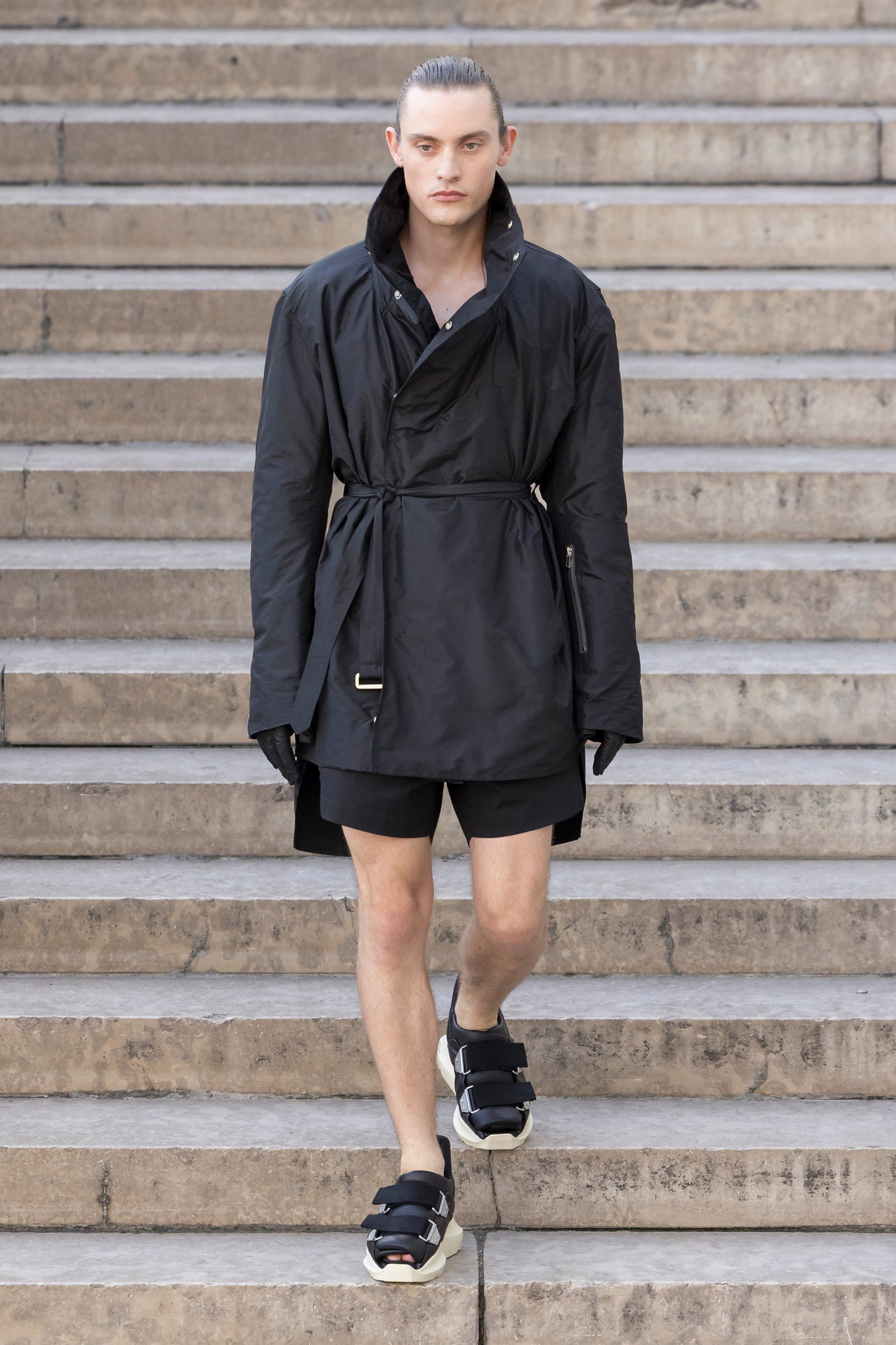 Rick Owens runway look featuring avant garde layered outfit with sculptural silhouette and dark tonal styling