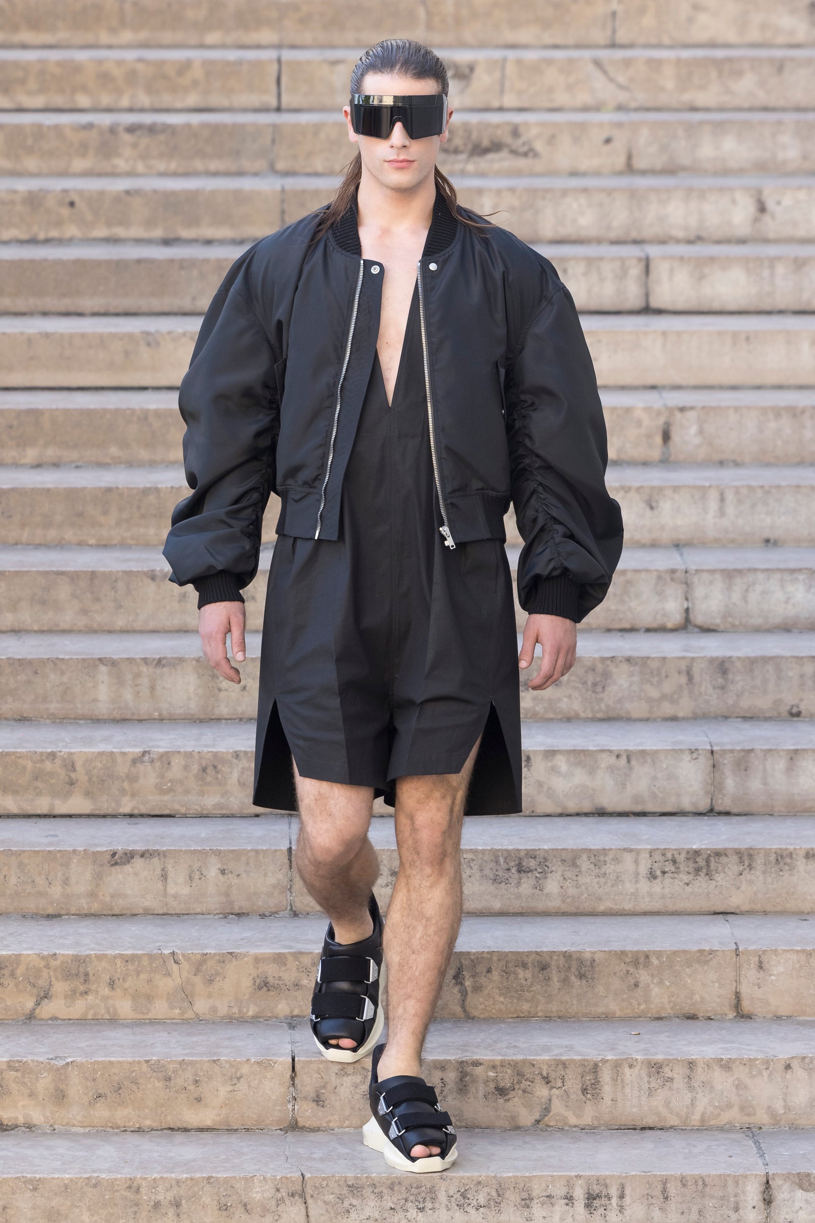 Rick Owens runway look featuring avant garde layered outfit with sculptural silhouette and dark tonal styling