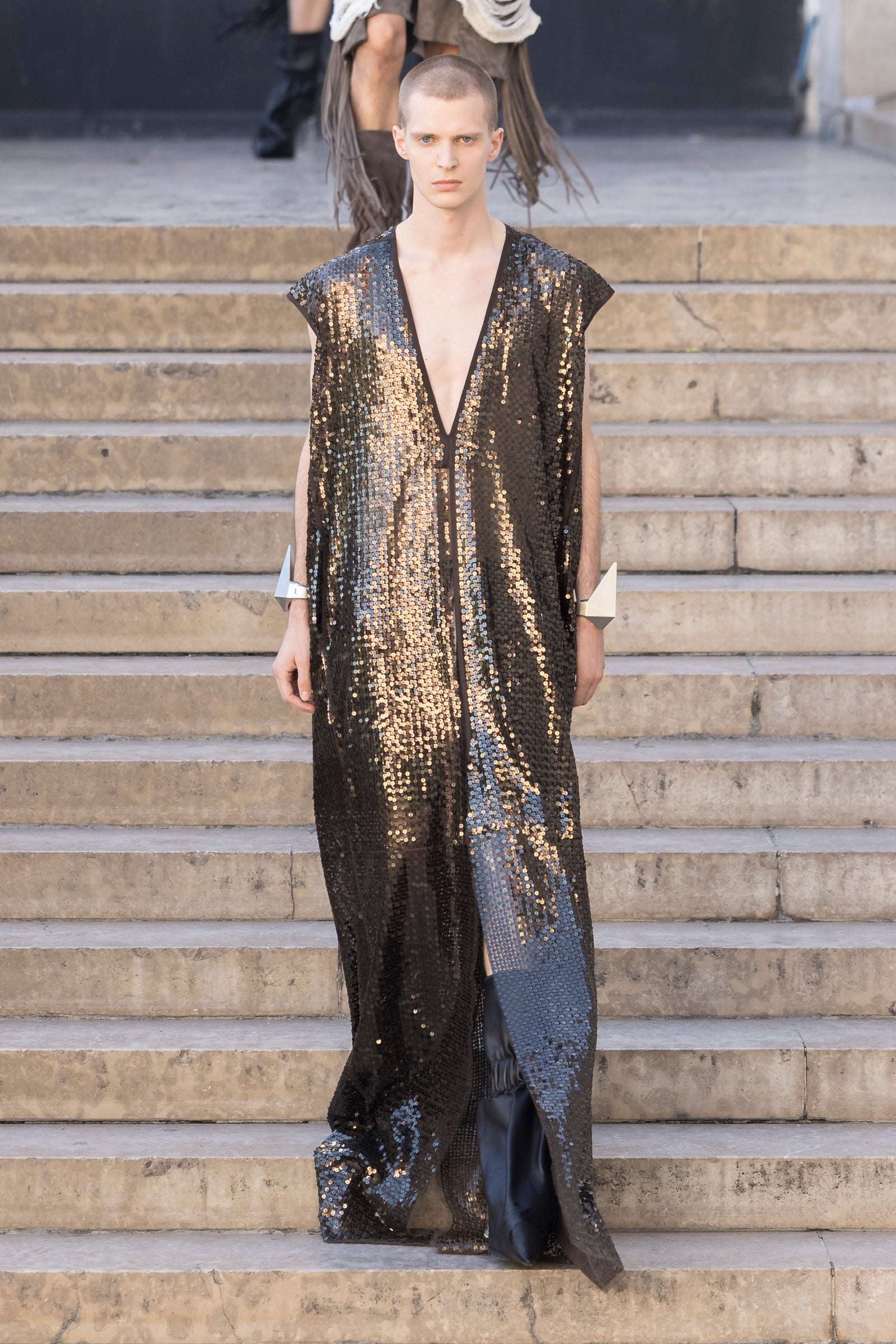 Rick Owens runway look featuring avant garde layered outfit with sculptural silhouette and dark tonal styling