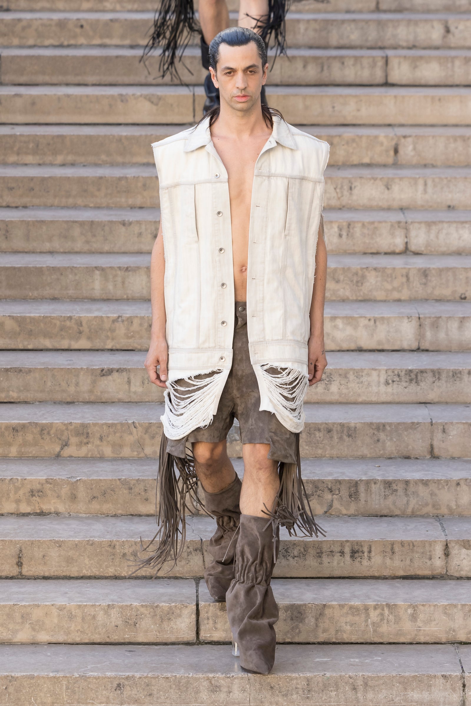 Rick Owens runway look featuring avant garde layered outfit with sculptural silhouette and dark tonal styling