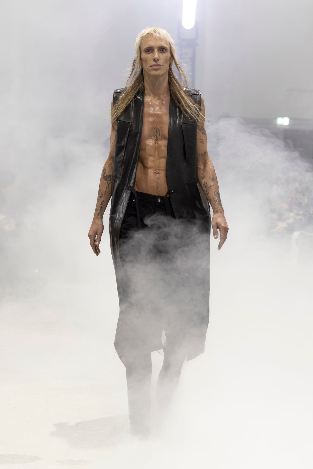 Rick Owens runway look featuring avant garde layered outfit with sculptural silhouette and dark tonal styling