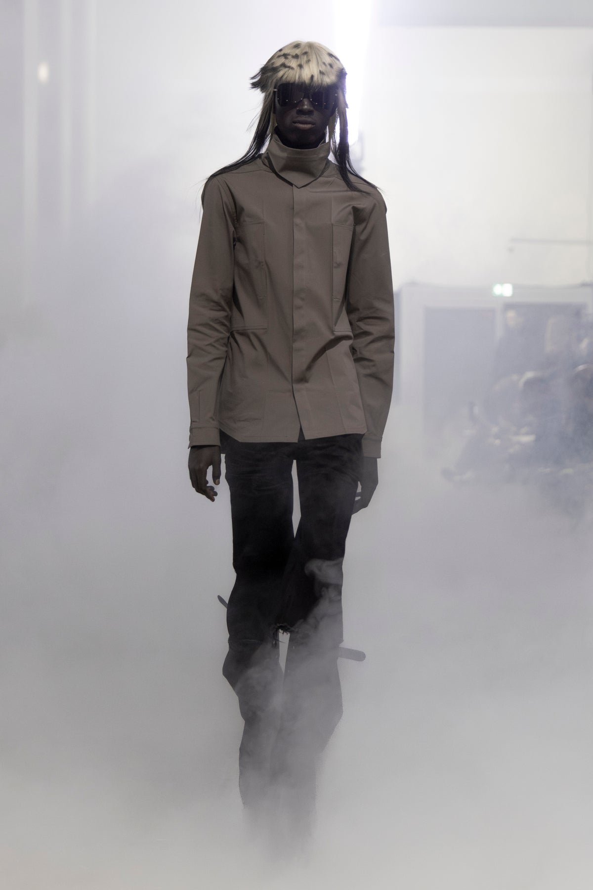 Rick Owens runway look featuring avant garde layered outfit with sculptural silhouette and dark tonal styling