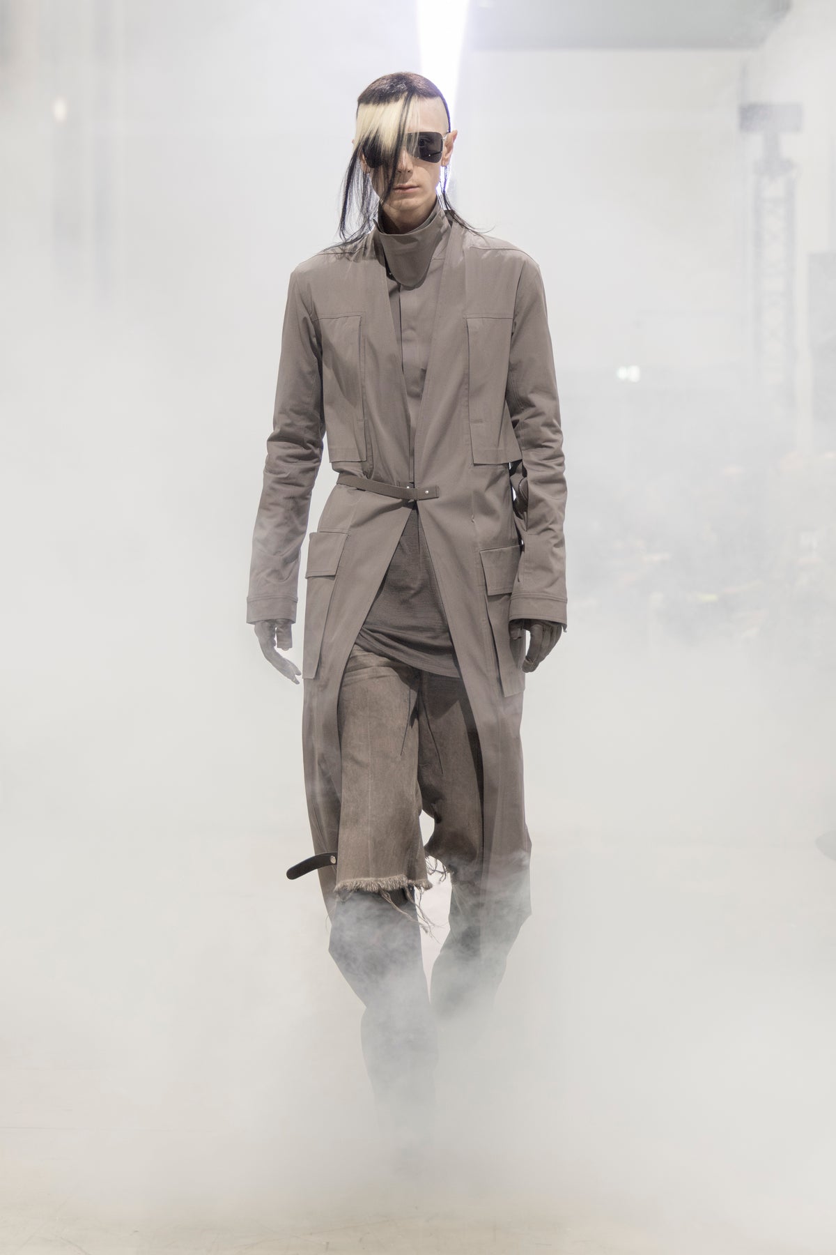 Rick Owens runway look featuring avant garde layered outfit with sculptural silhouette and dark tonal styling