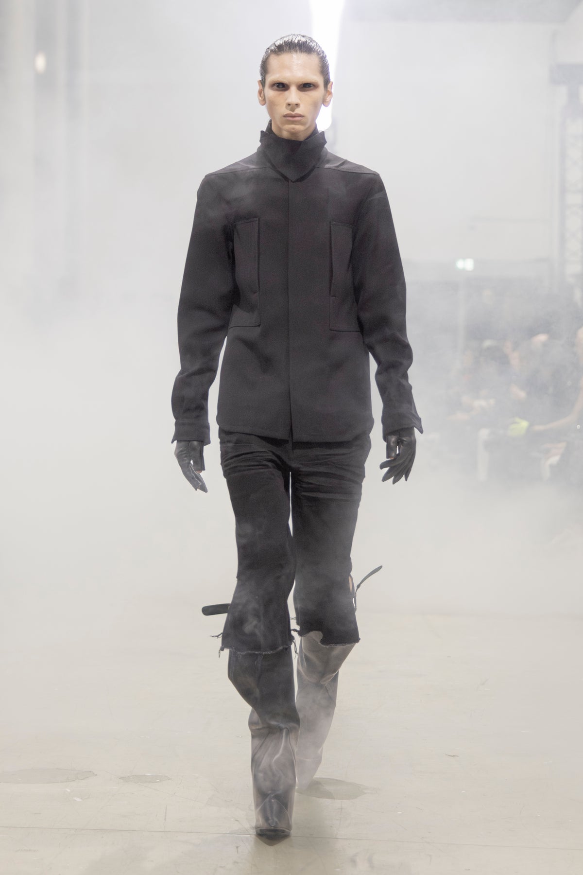 Rick Owens runway look featuring avant garde layered outfit with sculptural silhouette and dark tonal styling