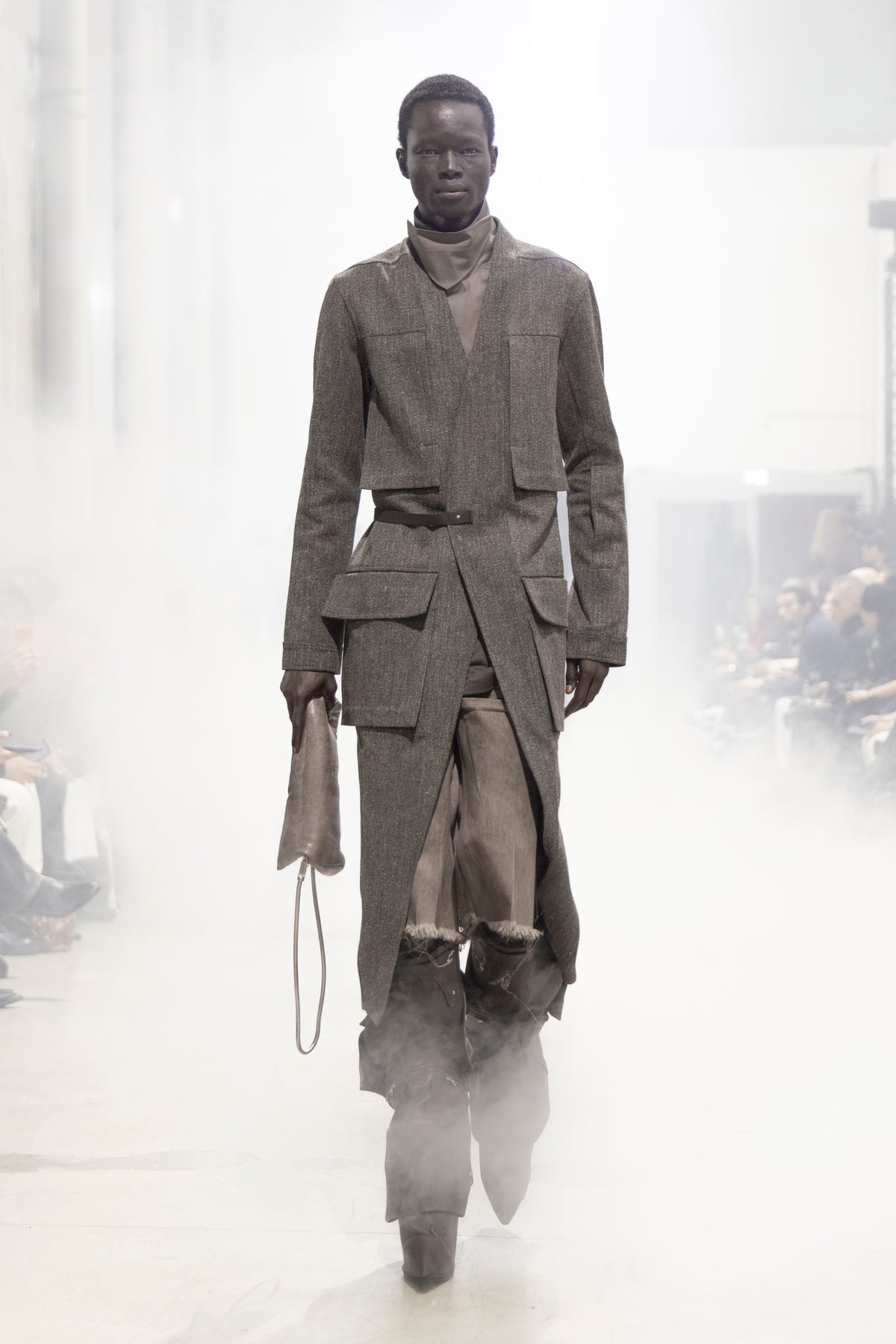 Rick Owens runway look featuring avant garde layered outfit with sculptural silhouette and dark tonal styling