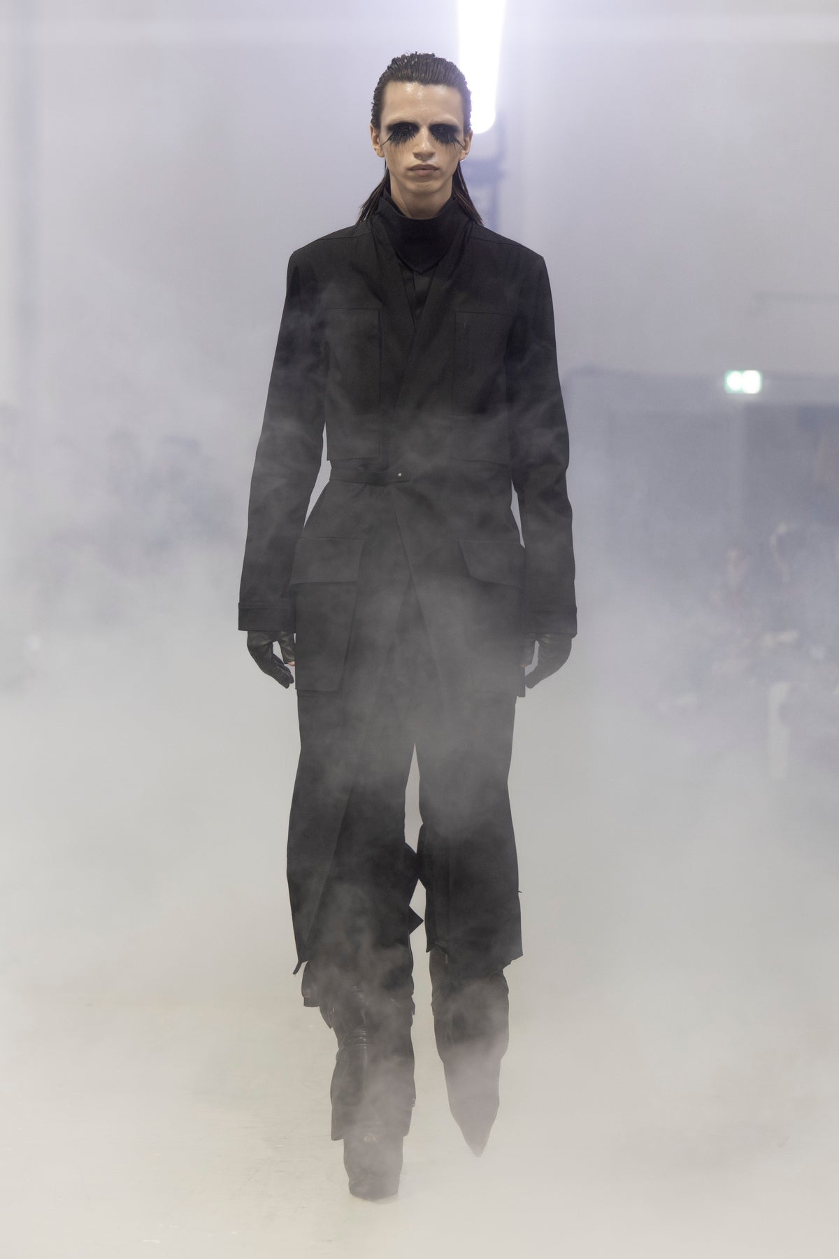 Rick Owens runway look featuring avant garde layered outfit with sculptural silhouette and dark tonal styling