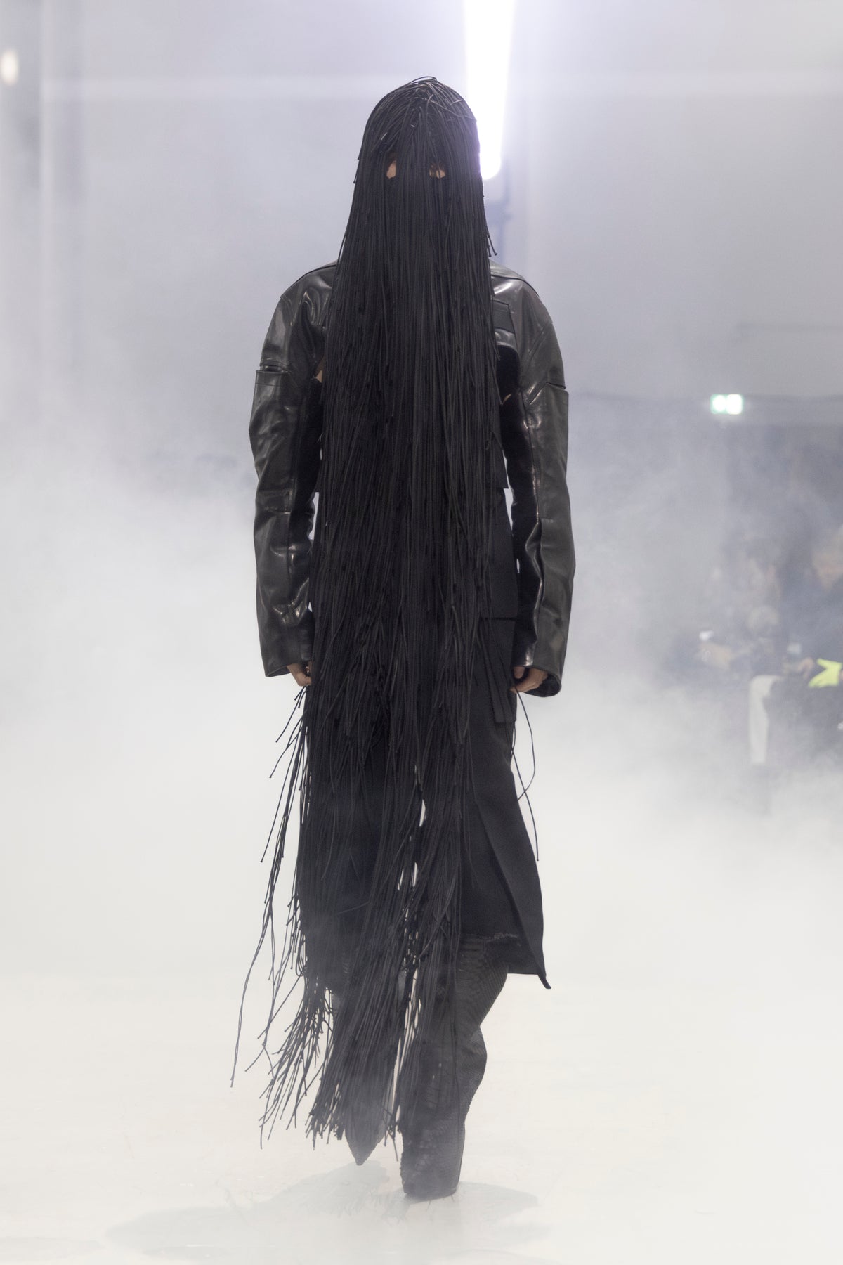 Rick Owens runway look featuring avant garde layered outfit with sculptural silhouette and dark tonal styling