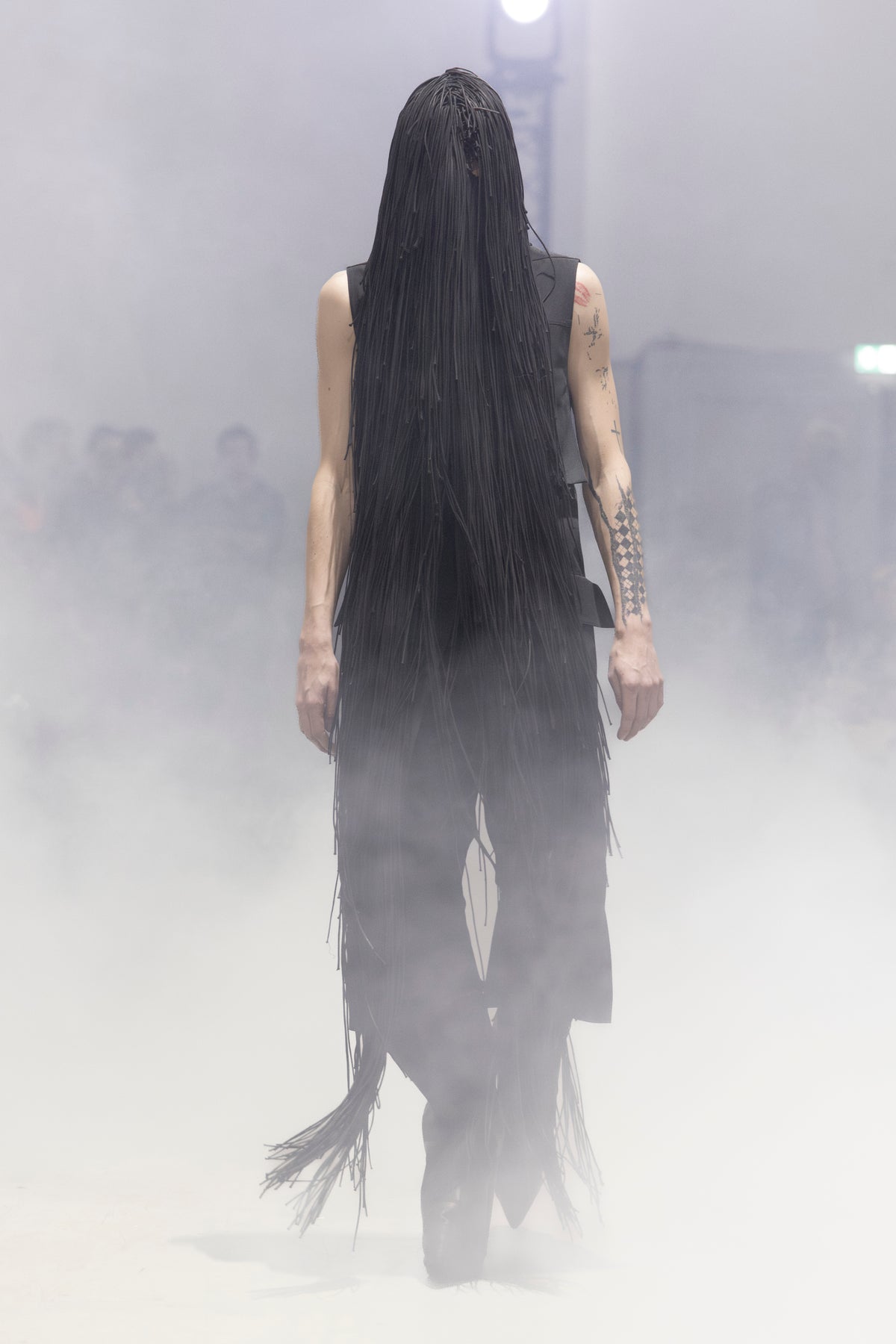 Rick Owens runway look featuring avant garde layered outfit with sculptural silhouette and dark tonal styling