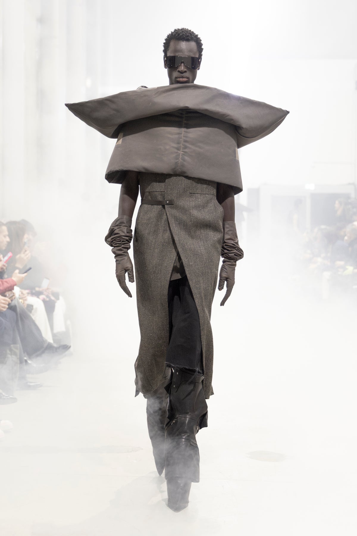Rick Owens runway look featuring avant garde layered outfit with sculptural silhouette and dark tonal styling