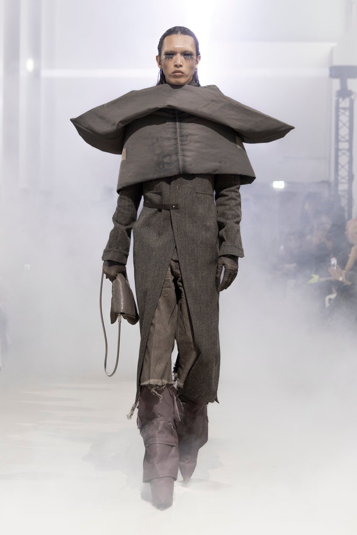 Rick Owens runway look featuring avant garde layered outfit with sculptural silhouette and dark tonal styling