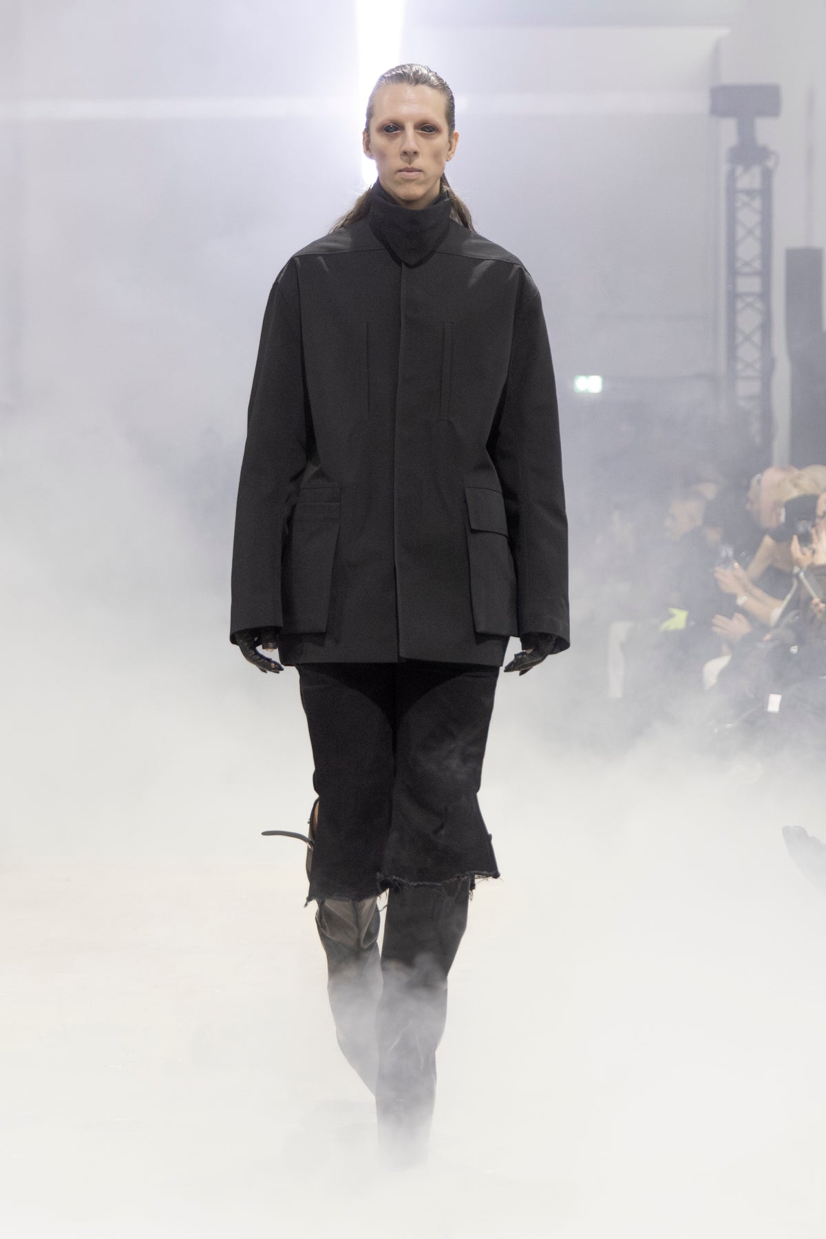 Rick Owens runway look featuring avant garde layered outfit with sculptural silhouette and dark tonal styling