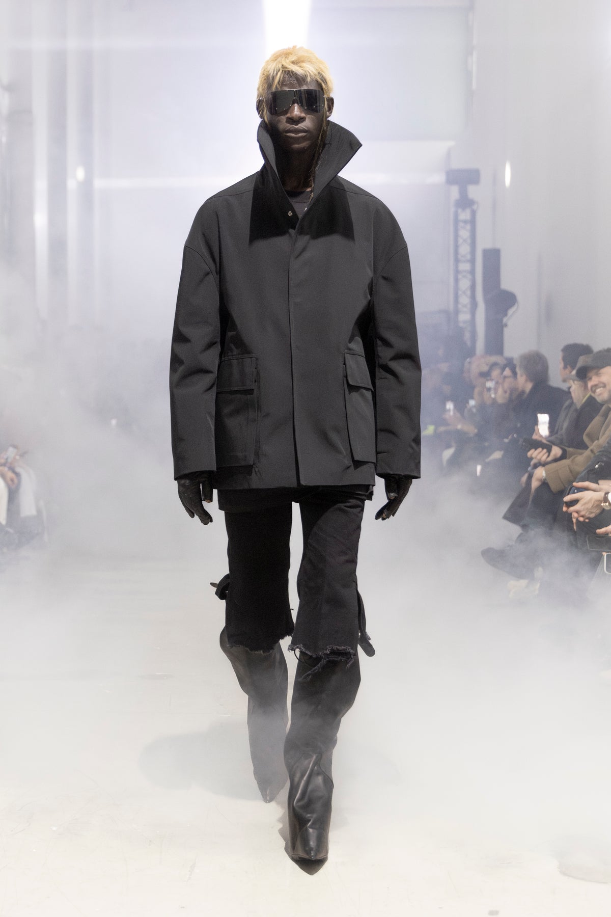 Rick Owens runway look featuring avant garde layered outfit with sculptural silhouette and dark tonal styling