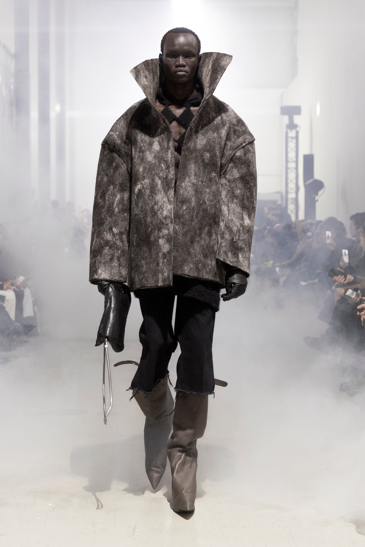 Rick Owens runway look featuring avant garde layered outfit with sculptural silhouette and dark tonal styling