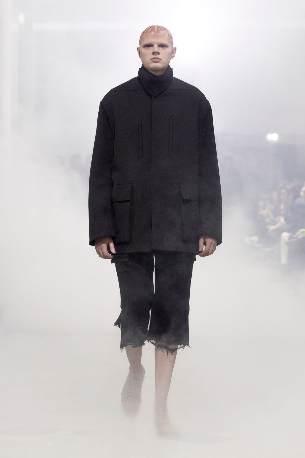Rick Owens runway look featuring avant garde layered outfit with sculptural silhouette and dark tonal styling