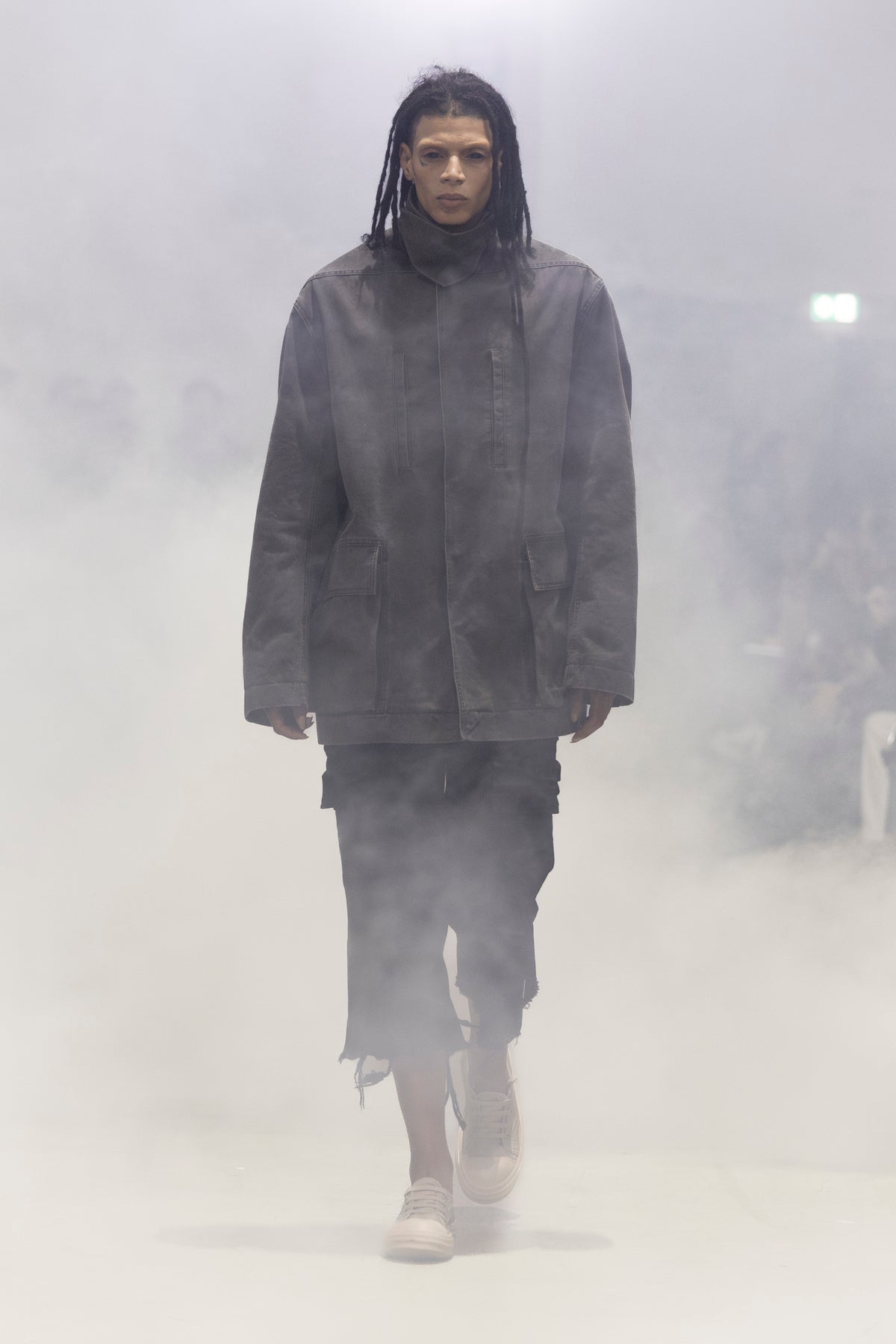 Rick Owens runway look featuring avant garde layered outfit with sculptural silhouette and dark tonal styling