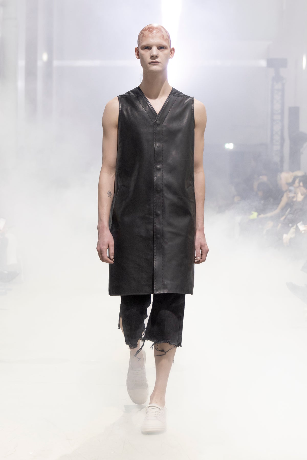 Rick Owens runway look featuring avant garde layered outfit with sculptural silhouette and dark tonal styling